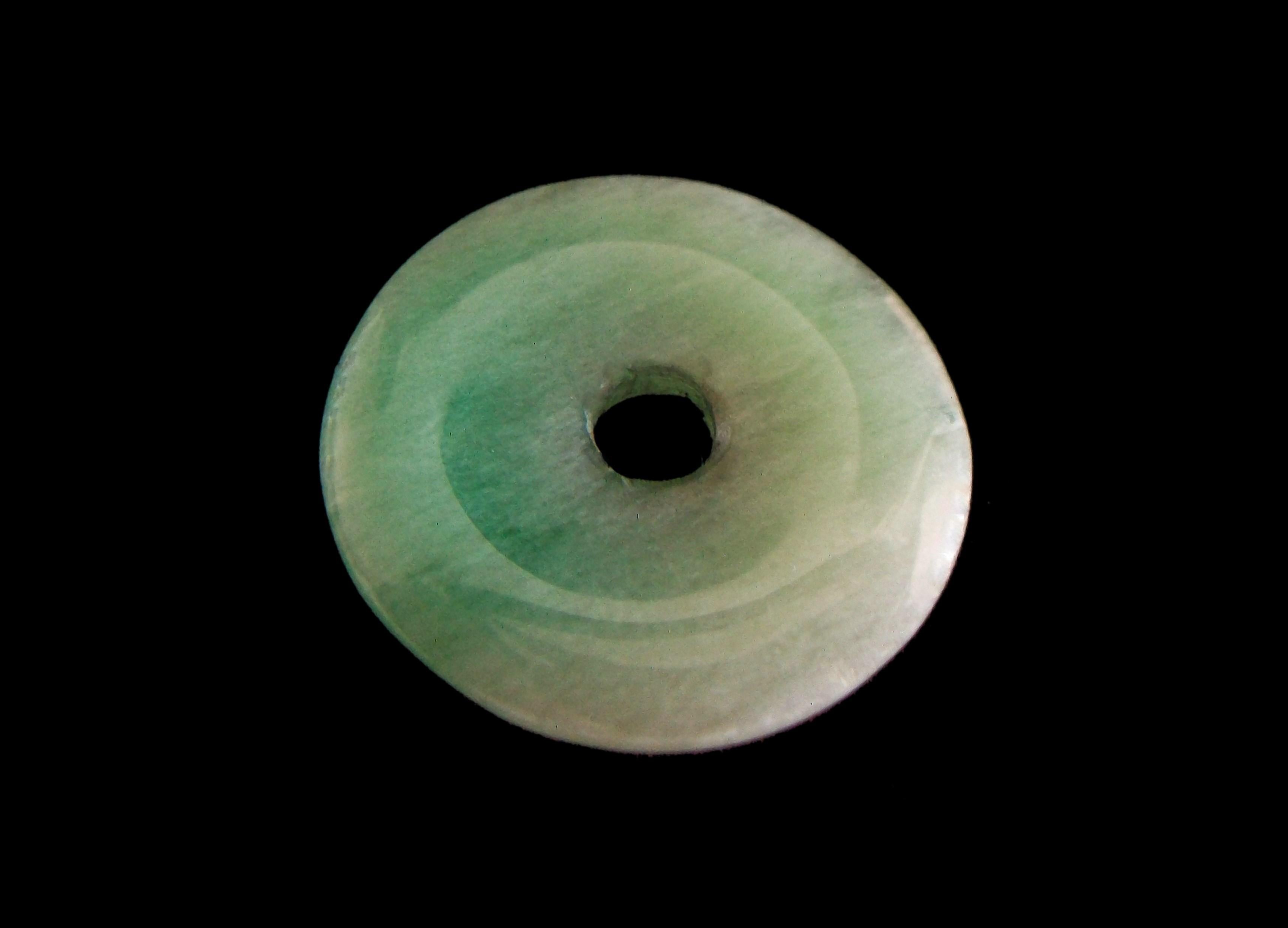 Vintage green nephrite round disk pendant - China - 20th century.

Excellent vintage condition - all original - no loss - no damage - no repairs - minor scratches from previous jewelry mounts - signs of age and use - ready to wear.

Size/Dimensions