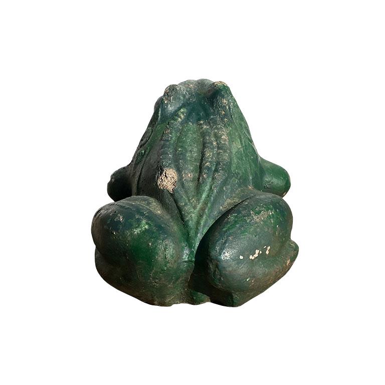 A rustic green concrete garden frog statue. Perfect for a summer garden, this concrete frog is painted in a chippy green. Its eyes are painted white with black centers. 

Dimensions:
10