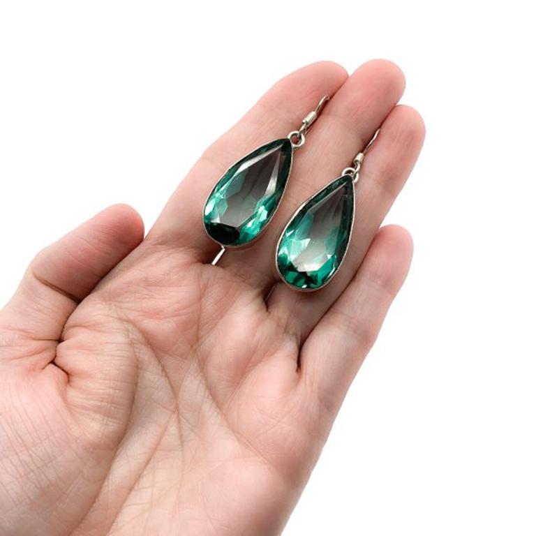 Vintage Green Teardrop Earrings. Stunning, large, deep, green faceted glass teardrop stones set in a deep silver plated band setting and topped with a 925 silver pierced shepherds hook style fitting. A truly beautiful deep hue of green emits from