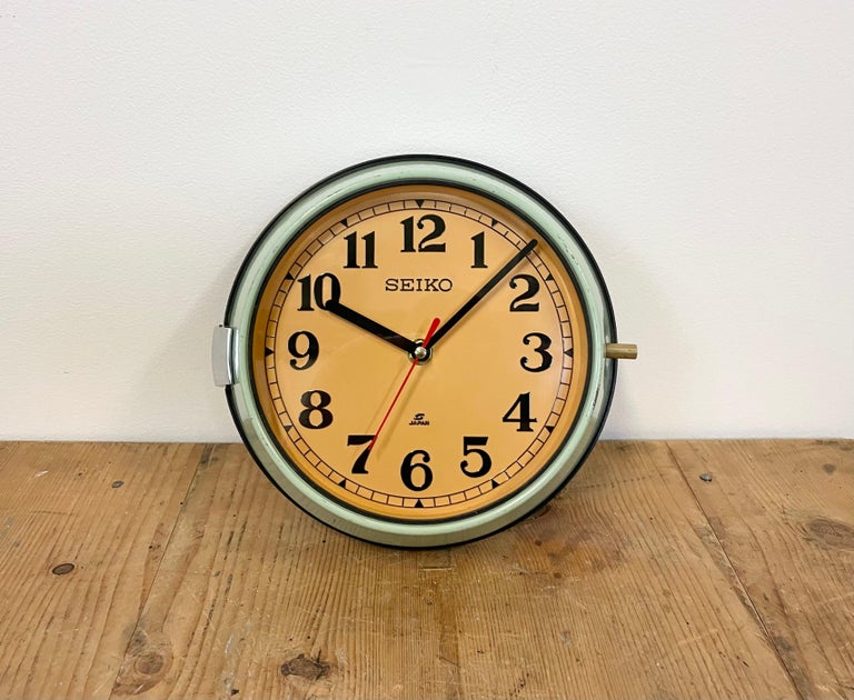 Vintage Seiko navy slave clock designed during the 1970s. These clocks were used on large Japanese cargo ships. It features a green metal frame, a plastic dial and clear glass cover. This item has been converted into a battery-powered clockwork and