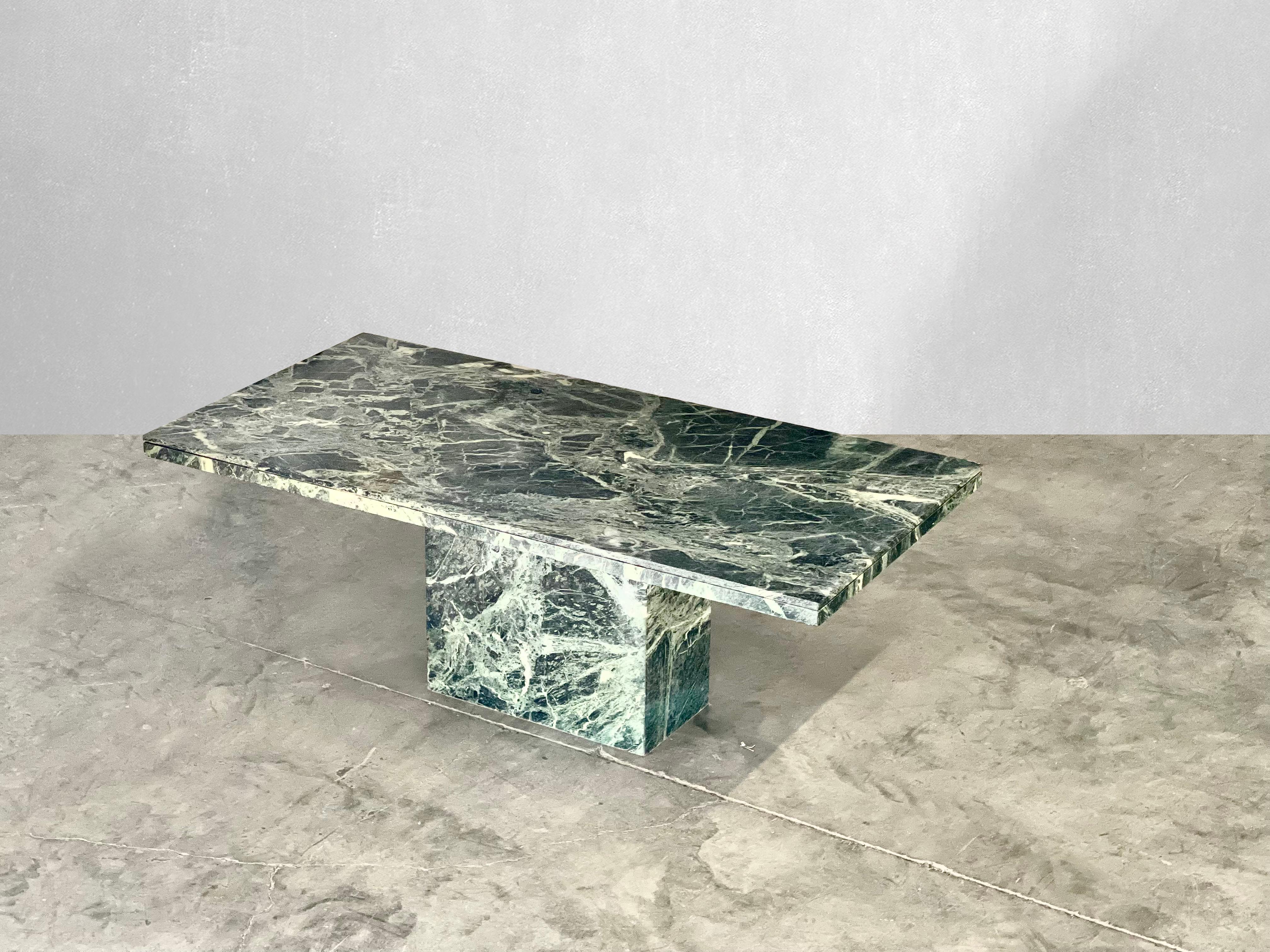Striking green serpentine marble dining table.

circa 1980.

Rectangular serpentine green marble table with beautiful edge detail and matching base. Love the natural movement and different shades of green. Pairs well with many different styles