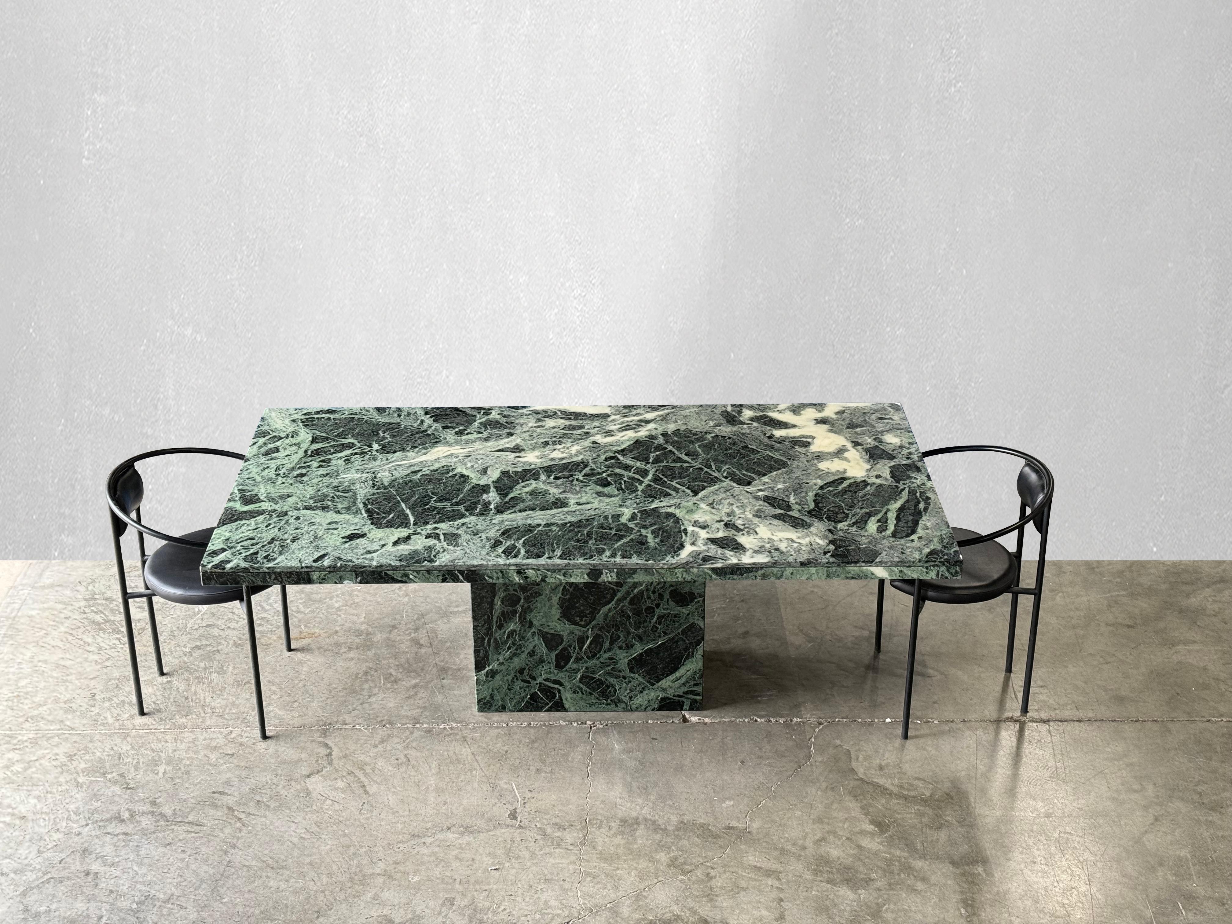 Striking green serpentine marble dining table.

circa 1980.

Rectangular serpentine green marble table with beautiful edge detail and matching base. Love the natural movement and different shades of green. Pairs well with many different styles of
