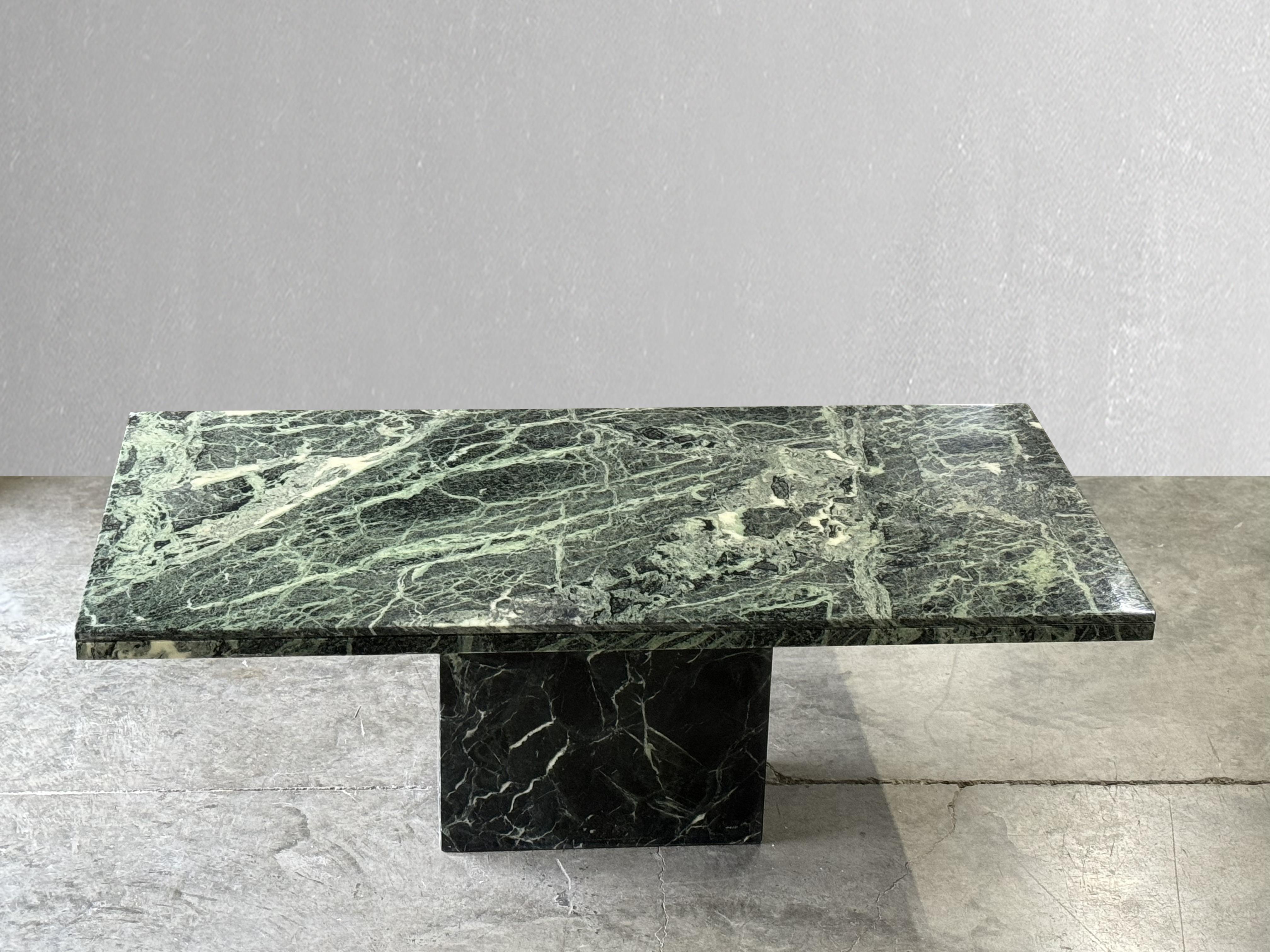 Striking Green Serpentine Marble Dining Table. 

C. 1980

Rectangular serpentine green marble table with beautiful edge detail and matching base. Love the natural movement and different shades of green. Pairs well with many different styles of