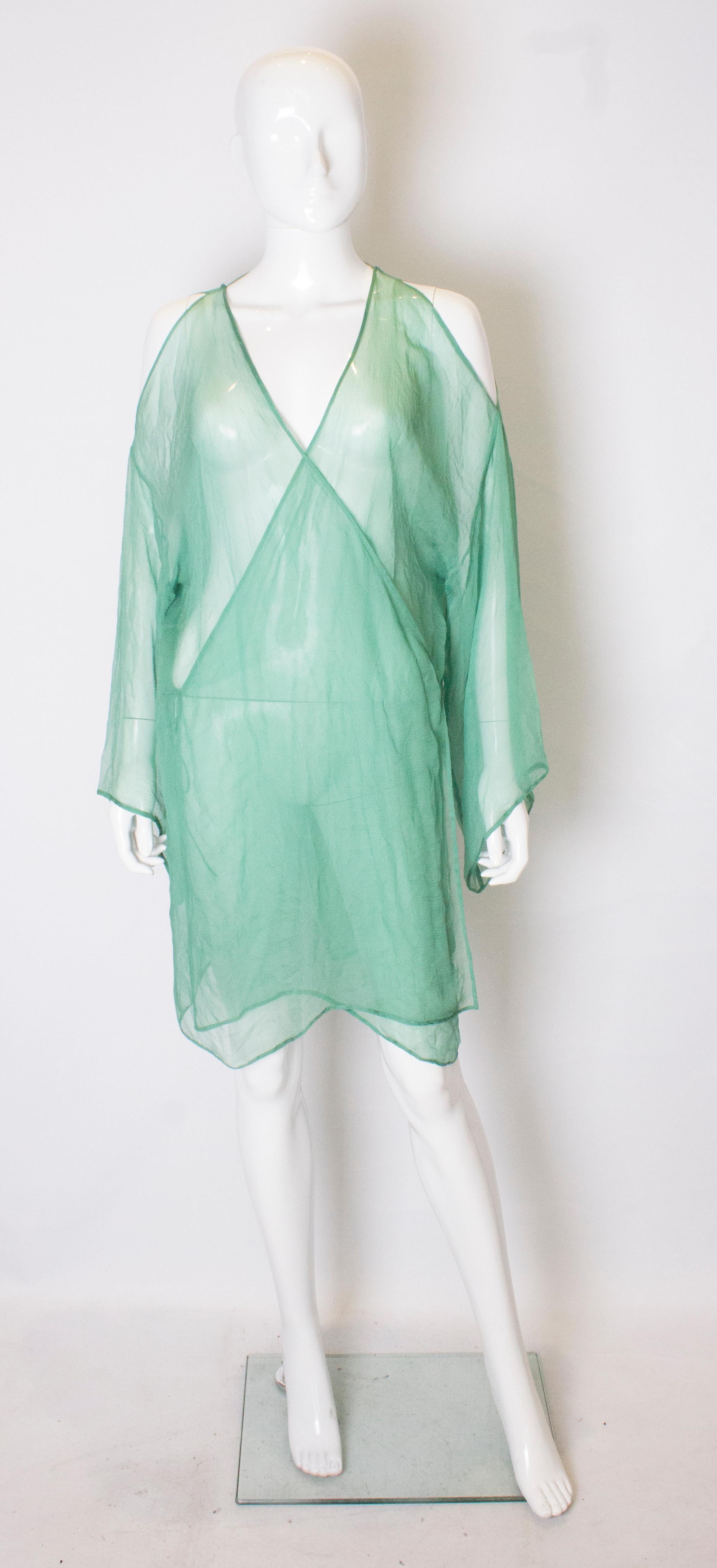 A great, green vintage silk chiffon top. The top has a v neckline and backine, and elbow length sleaves.