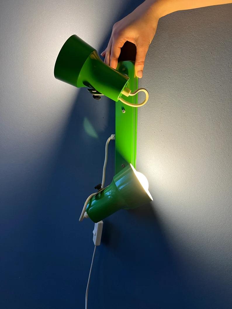 Mid century space age wall lamp in green colour. The two spots can be positioned in any way desirable. The lamp requires two E27/26 lightbulbs and currently has an EU-plug.

Additional information:
Materials: Metal
Period: 1970s
Dimensions: Height: