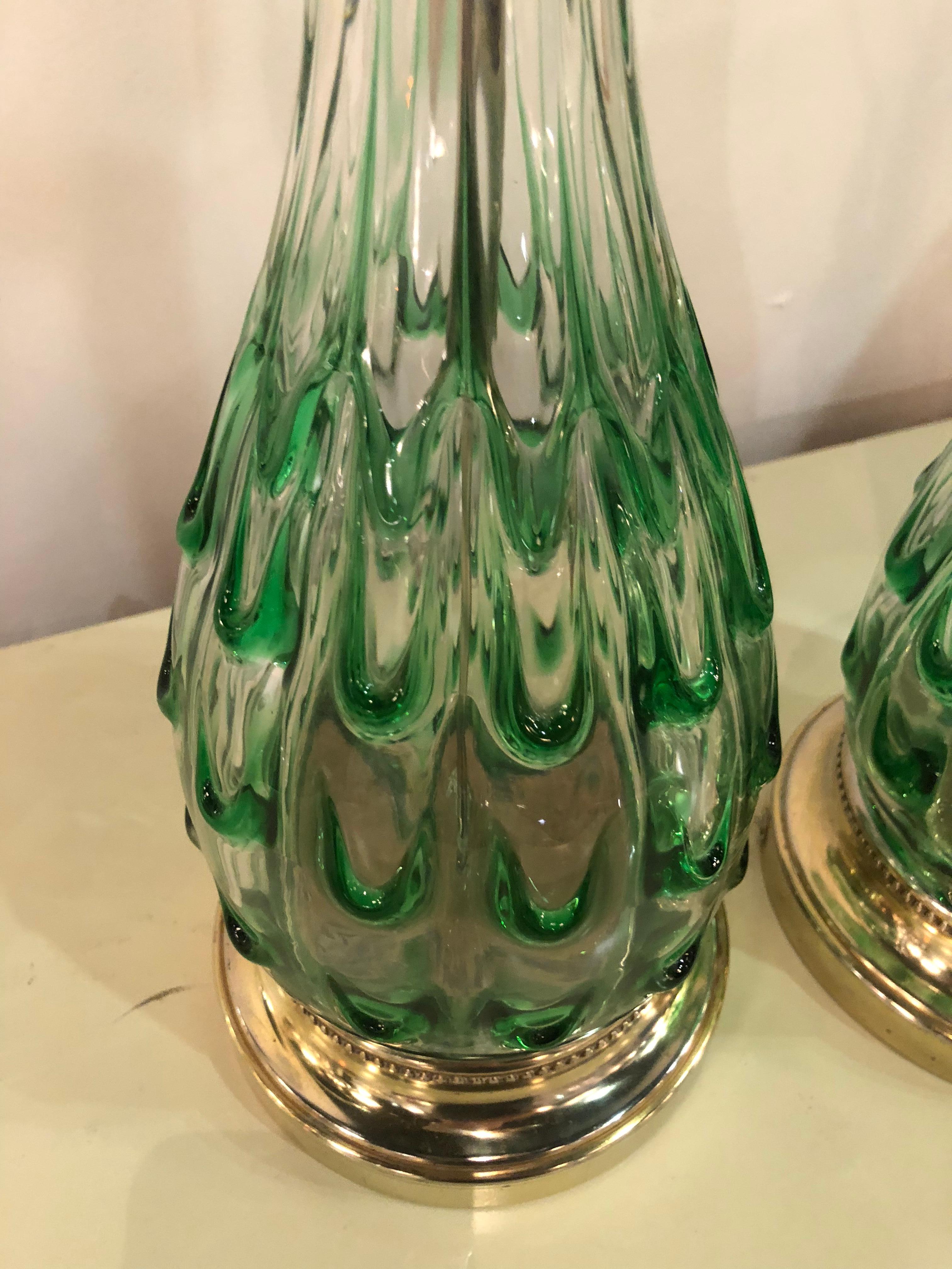 Pair of vintage green swirl glass Murano table lamps. These have been professionally rewired, new brass hardware, Lucite finials. The bases are original and have been polished but do have some minor natural patina to them.
Measures: 35.75 tall to
