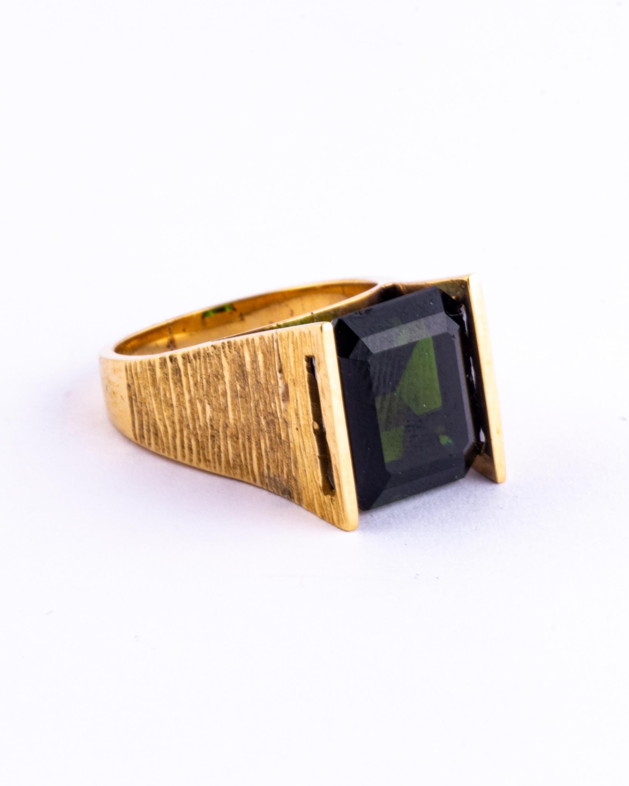 The deep green tourmaline is gorgeous and set simply up high in this 9 carat gold ring. The wide band has textured detail and has a futuristic feel about it. 

Ring Size: L or 5 3/4
Height Off Finger: 9mm
Stone Diameter: 12x10.5mm

Weight: 7.6g