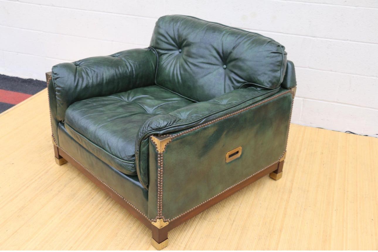 Beautiful club chair with ottoman made of leather, wood base, and brass details. Both chair and ottoman are in good vintage condition. They have no damages, and the bottoms are well attached. The chair is very sturdy and comfortable. Wonderful set