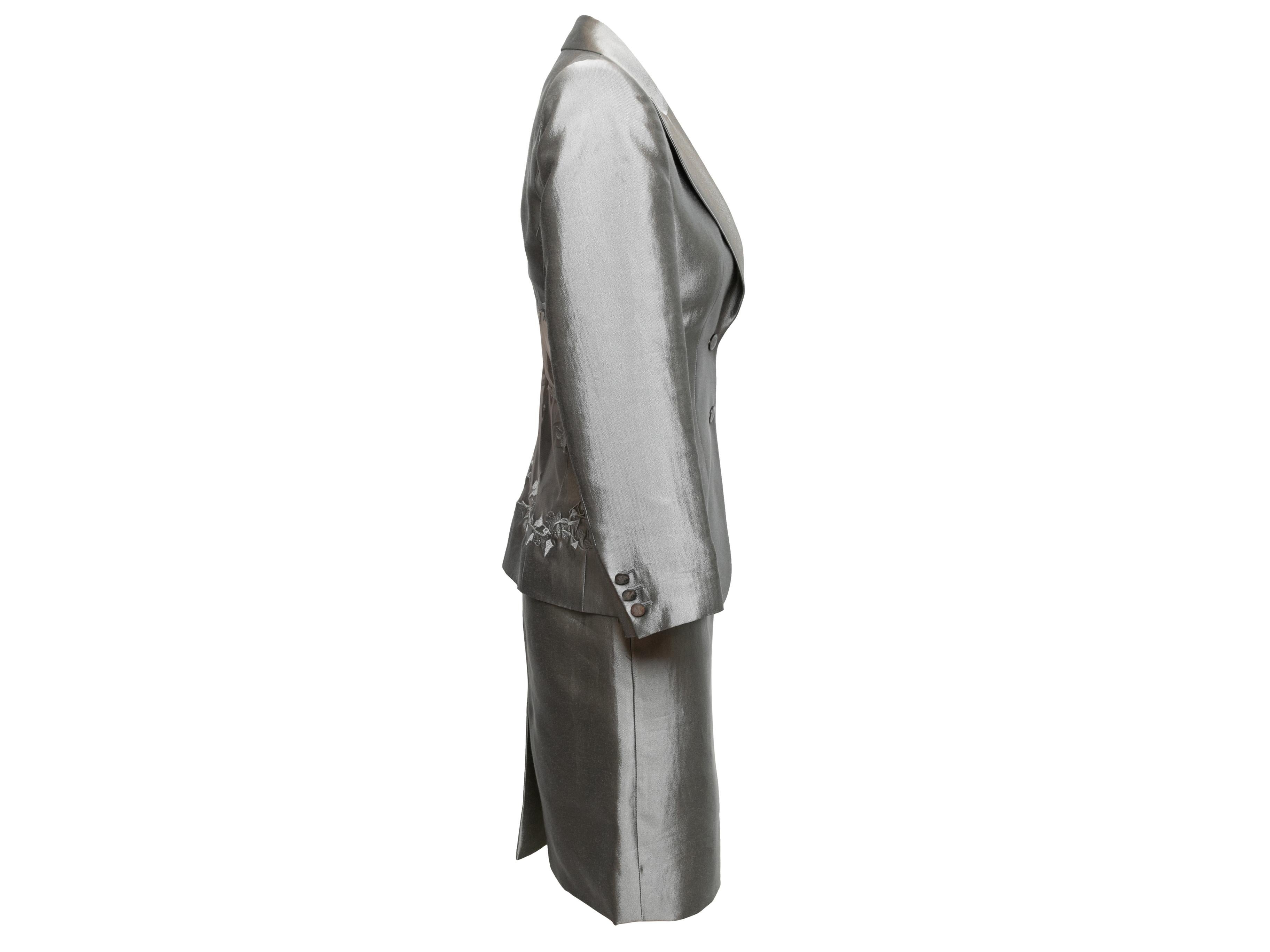 Vintage grey satin skirt suit by Alexander McQueen. Look #52 from the Spring/Summer 1999 Runway Collection. Blazer features peaked lapel, embroidery at side and back, single bust pocket, and front button closures. Skirt features button closures at