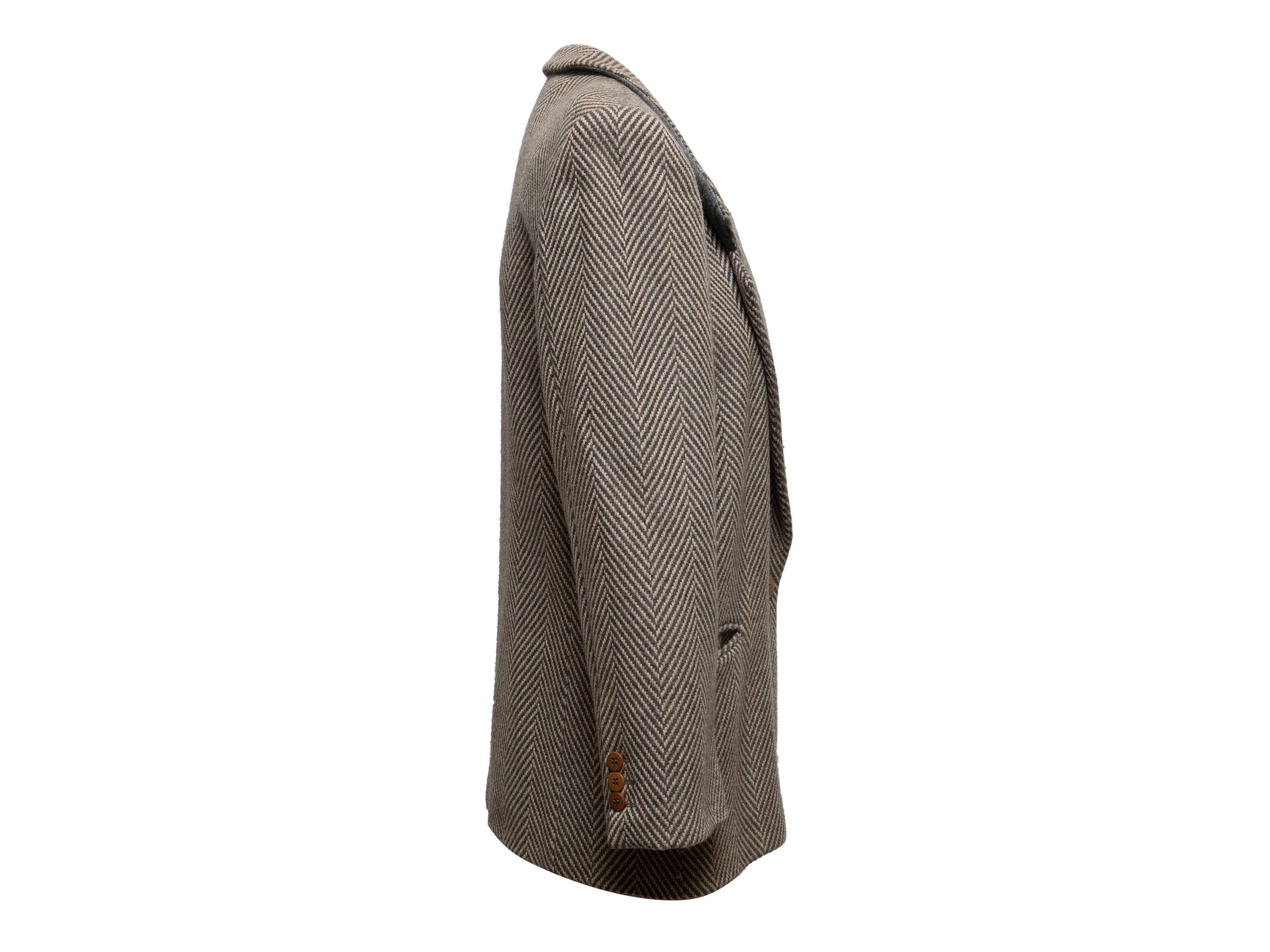 Vintage grey and beige virgin wool herringbone blazer by Giorgio Armani. Notched lapel. Three pockets. Single button closure at front. 34