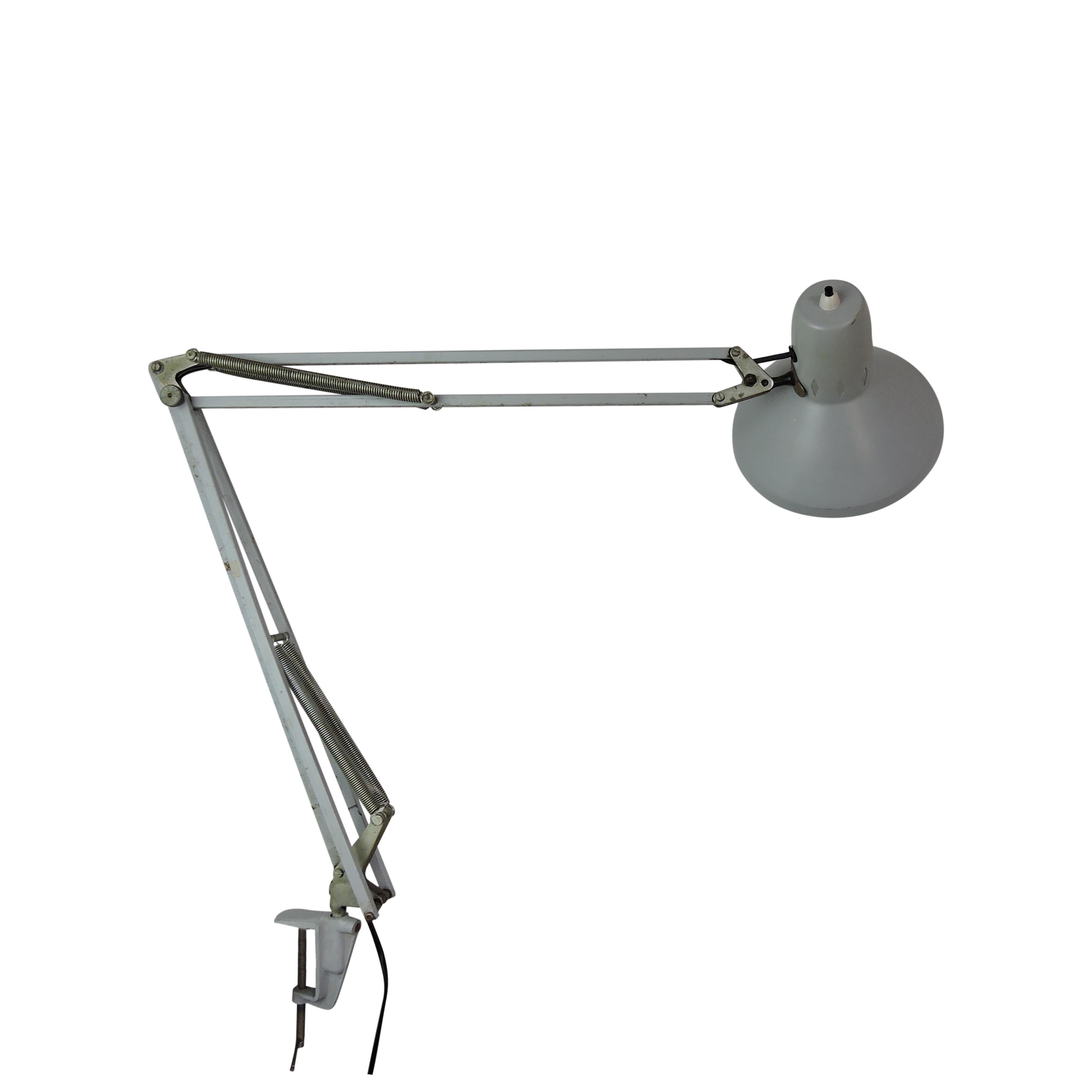 This grey lamp from the 1960s can be fixed to a desk or shelf using a vice.
