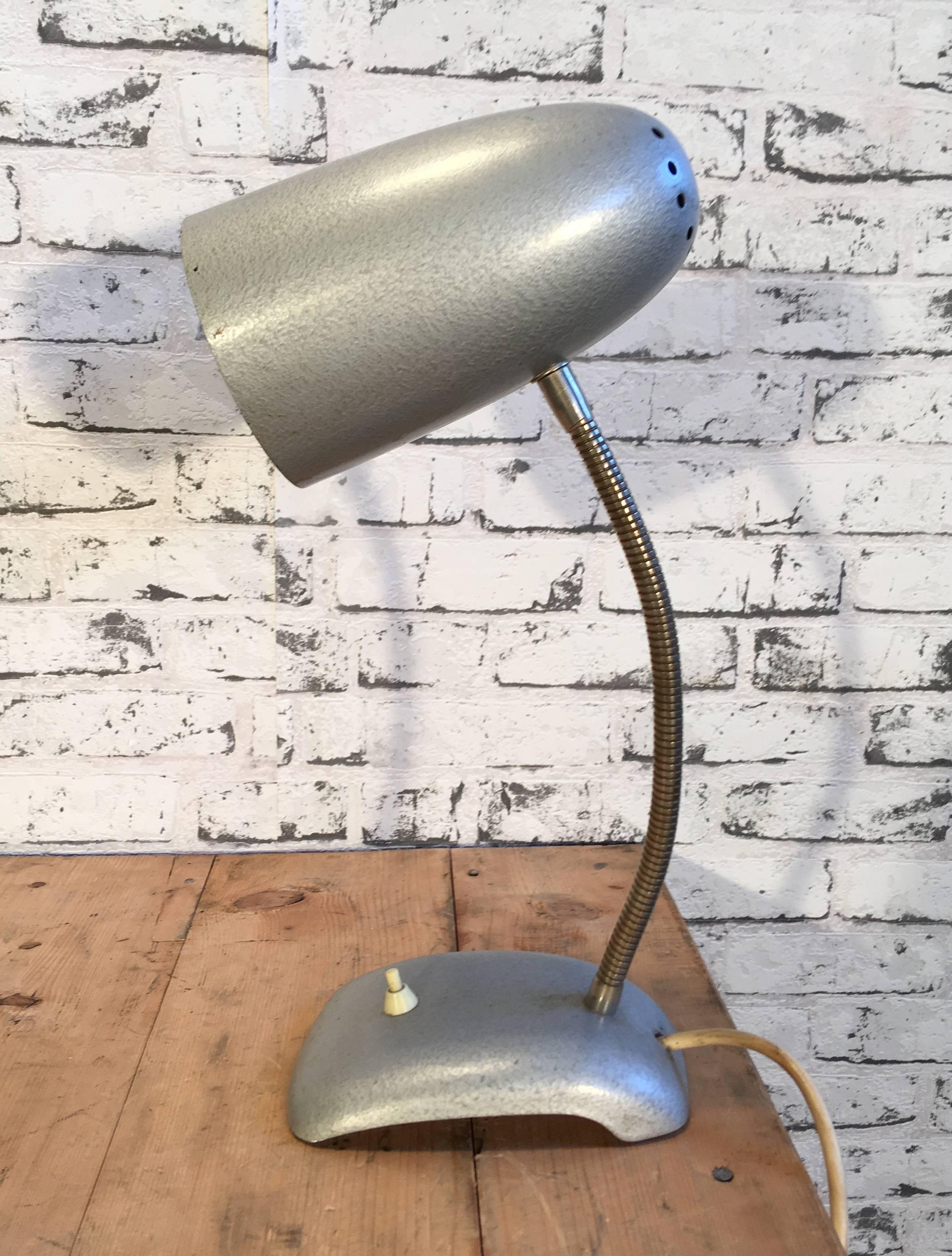 This vintage industrial table lamp has grey hammerpaint body and chrome gooseneck. 
Lamp is in very good vintage condition and fully functional.
Measures: Height: 43.0 cm
Depth: 19.0 cm
Diameter 11 cm.