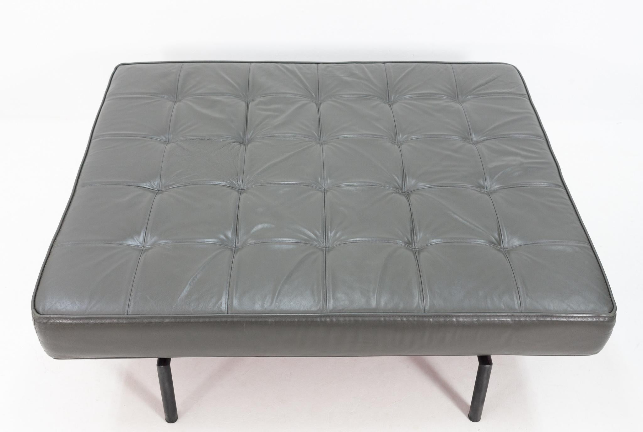 Large tufted grey leather pouf / ottoman. Great looking pouf. Black round metal feet, 1970s.
    