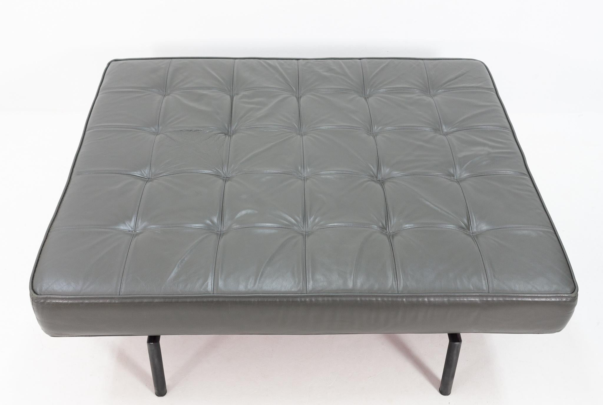 Large tufted grey leather pouf / ottoman. Great looking pouf. Black round metal feet, 1970s.
  