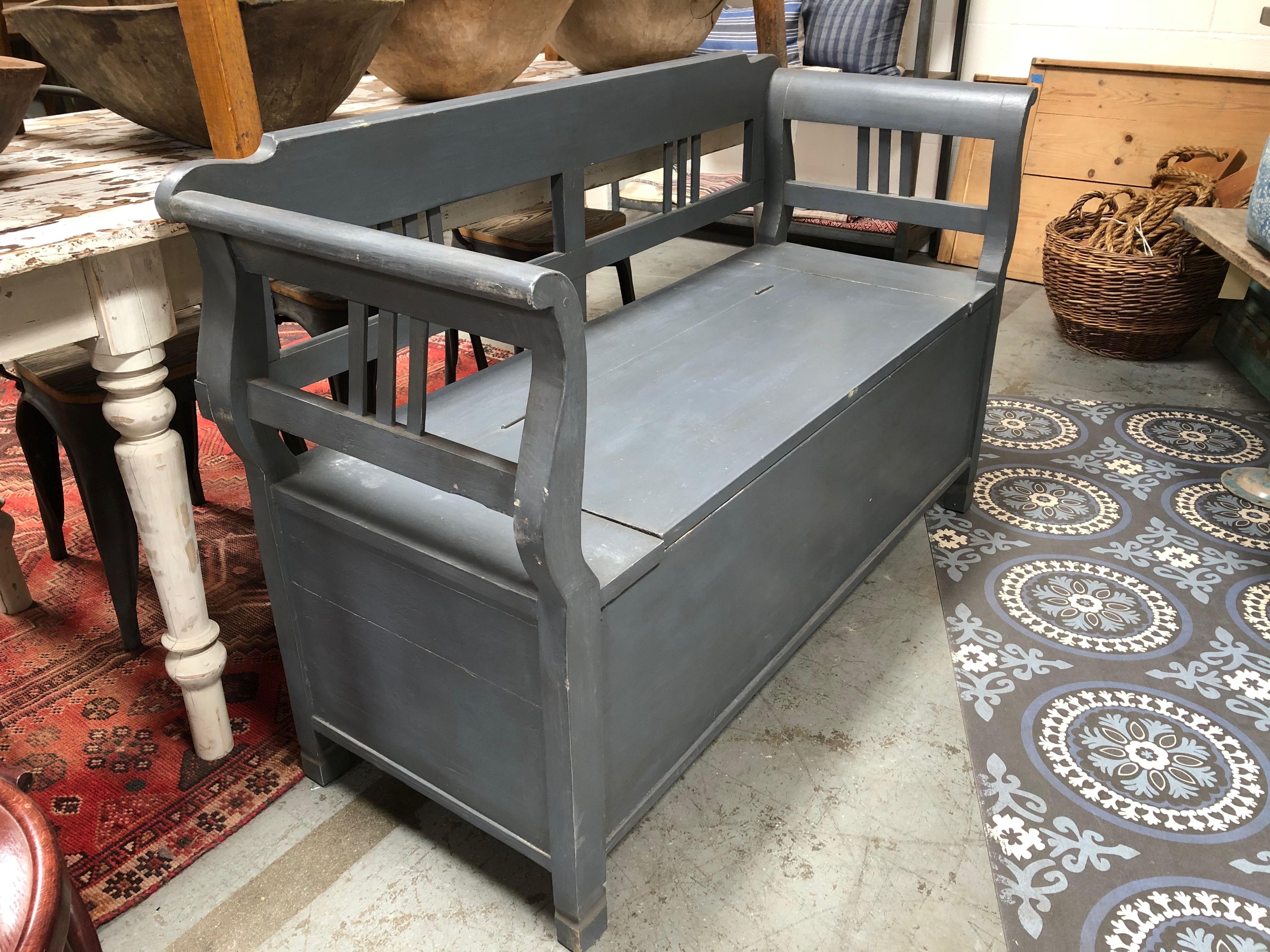 This vintage painted light grey bench features a storage area under the seat (see pictures). Made of wood, the condition is in good vintage condition and consistent with age. 

53”W x 21”D x 34”H
Seat height - 19”.
  
 