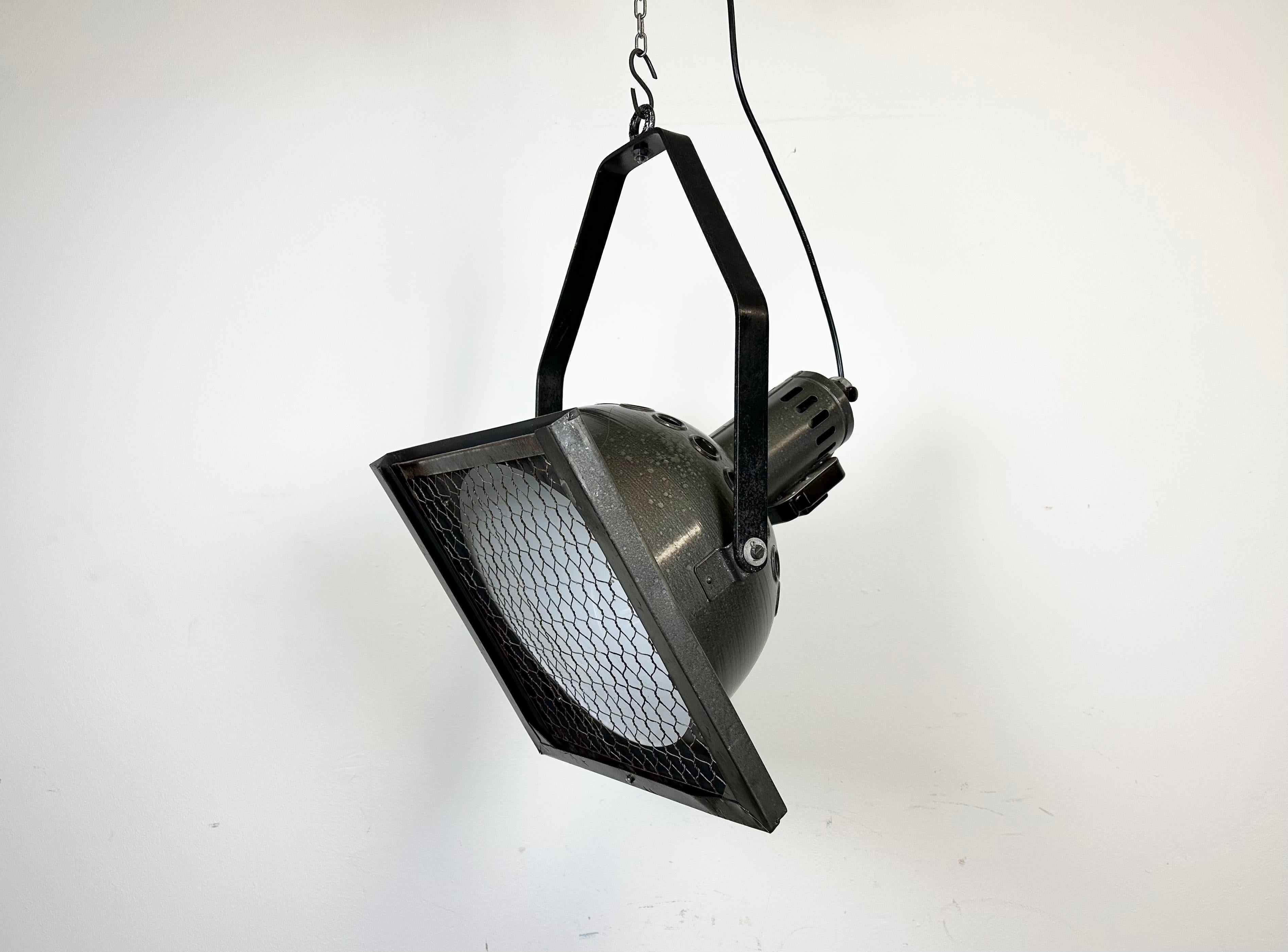 - Vintage theatre spotlight made by Elektrosvit in former Czechoslovakia during the 1970s.
- It features a grey hammerpaint metal body with white interior and iron grid.
- Adjustable angle
- The porcelain socket requires E27/ E26 lightbulbs 
- New
