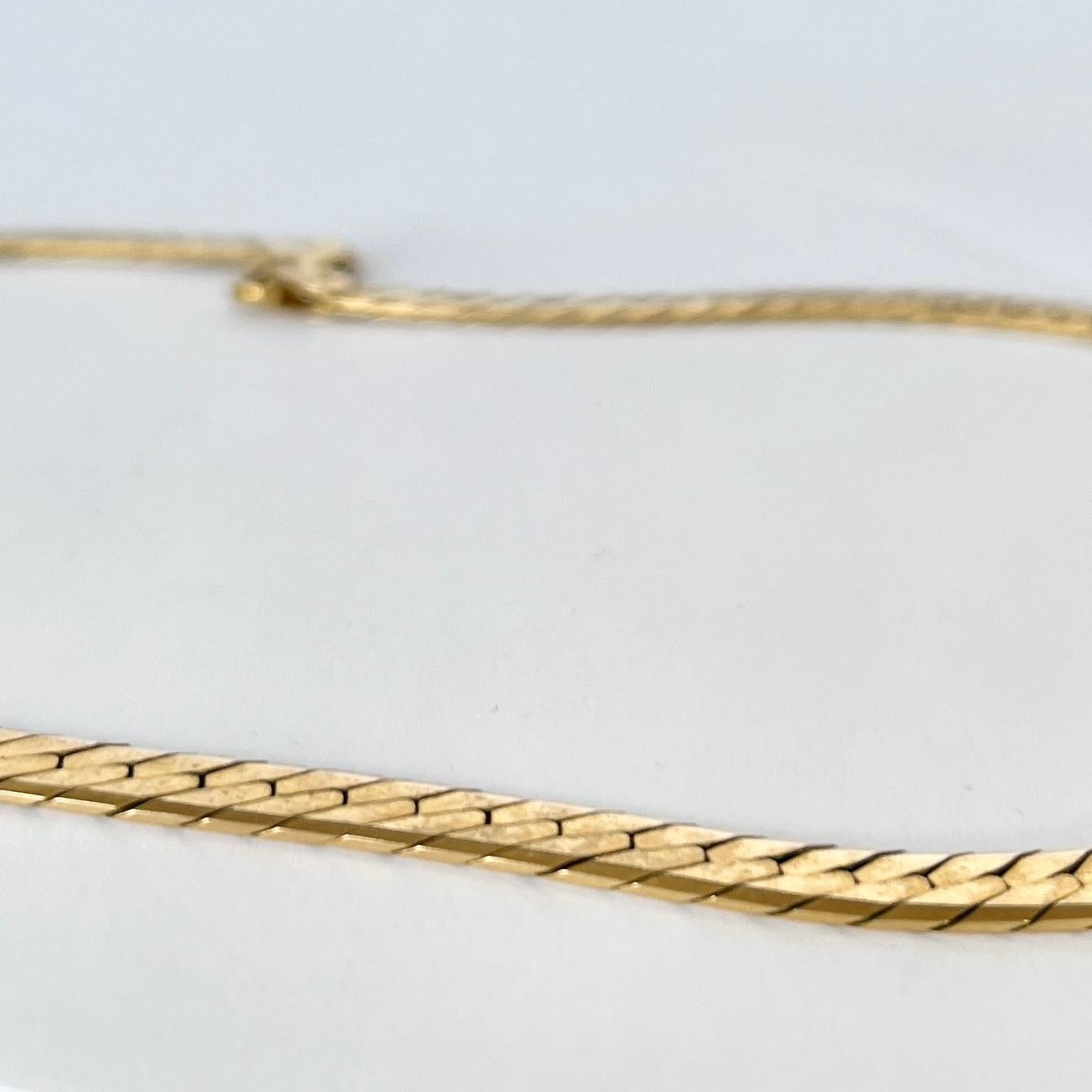 This beautiful vintage 9ct gold collar is flat and sits beautifully. It is fastened using a simple clasp.

Length: 40.5cm
Width: 6mm 

Weight: 19.9g