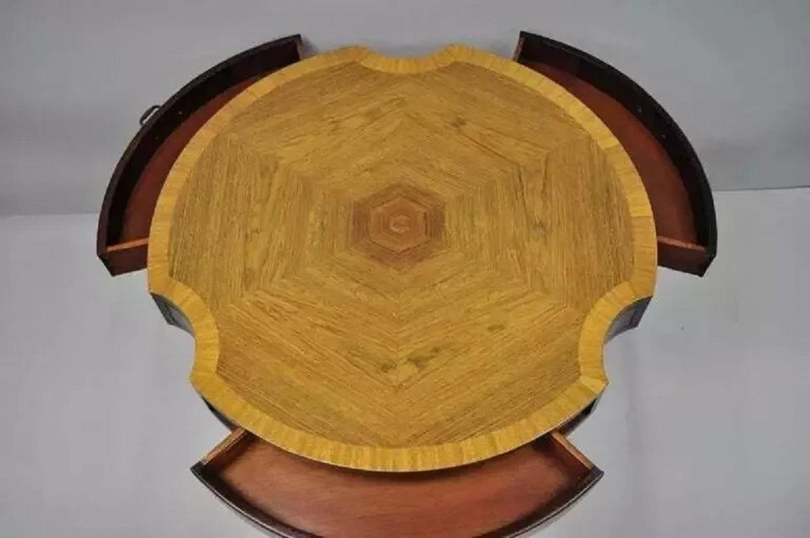 Vintage Grosfeld House Regency Mahogany & Rosewood 3 Drawer Pedestal Drum Table. Item features a shaped banded rosewood top, paw foot tripod pedestal base, beautiful wood grain, original label, 3 dovetailed drawers, quality American craftsmanship.