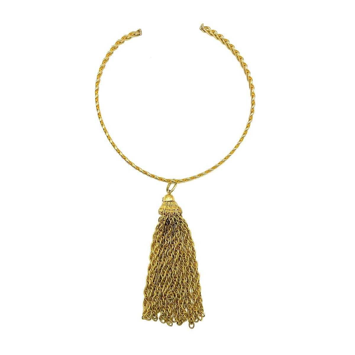 A striking Vintage Grosse Tassle Choker necklace straight out of the 1970s and 1970 to be precise. Crafted in gold plated metal. A crisscross patterned collar gives way to a neck enhancing long drop tassle that moves beautifully being created from