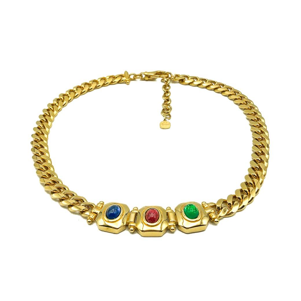 A Vintage Grossé Jewelled Collar. Featuring a flattened curb link chain set with a panel comprising cabochon glass stones emulating a sapphire, ruby and emerald. Finished with a statement style clip and extender chain with Grosse hangtag. In very