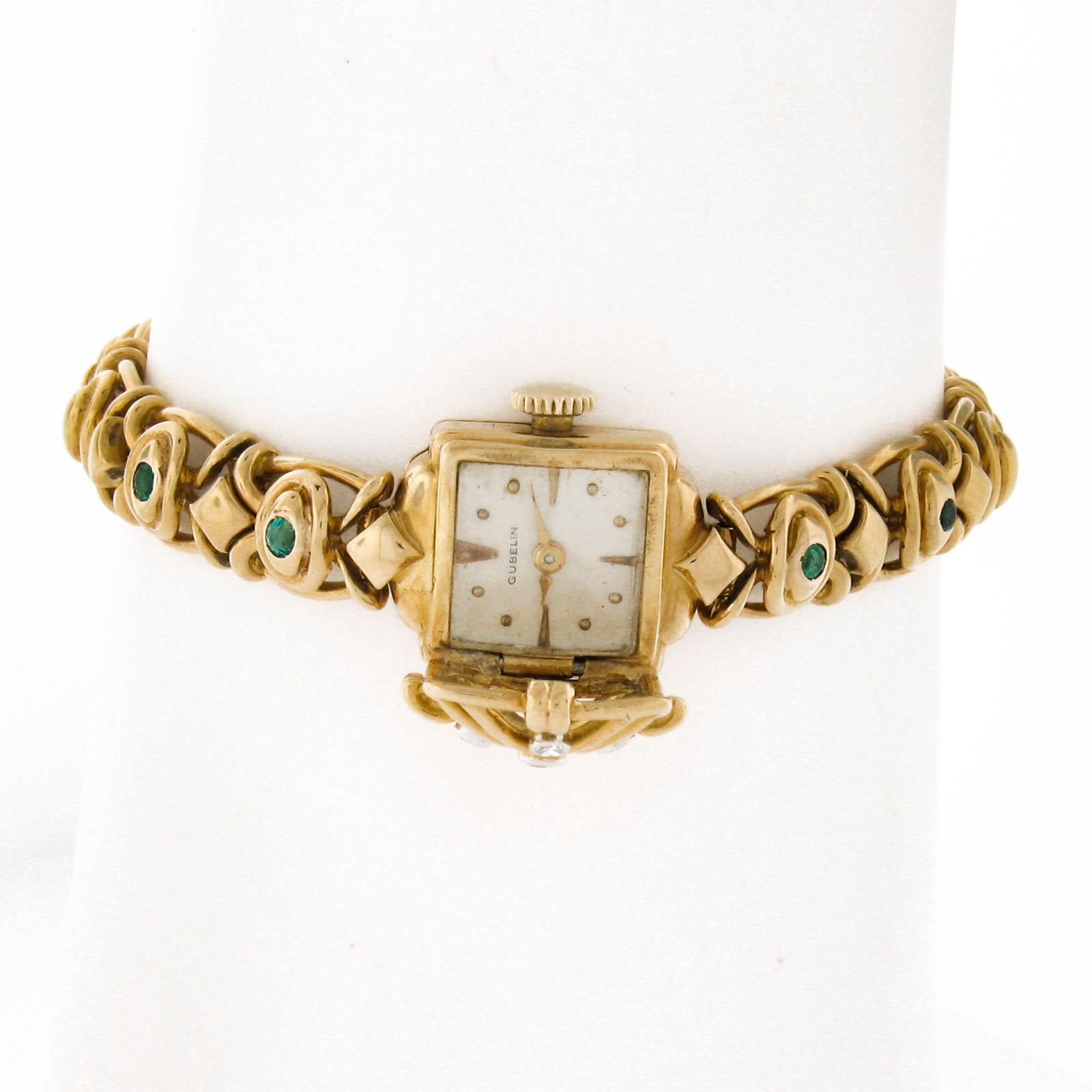 This stunning vintage ladies' Gubelin wrist watch features a 14mm solid 18k yellow gold square shaped case that is hidden under a unique diamond encrusted case cover. The beautiful bracelet is also set with natural green emeralds and is designed
