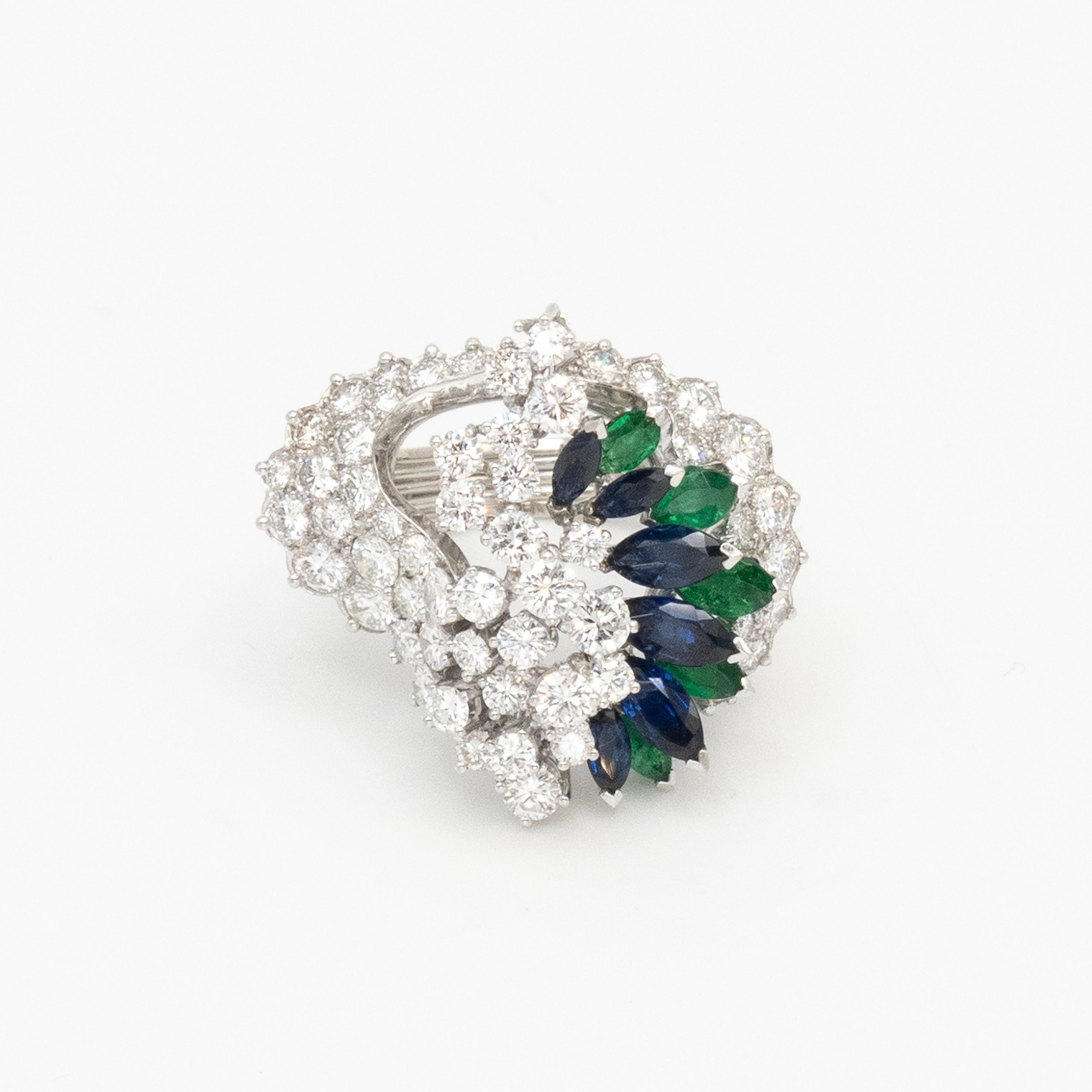 Stunning Gubelin platinum diamond blue Sapphire and emerald cocktail ring from 1960s set with high quality diamonds in F color VS1 clarity, accented with marquise sapphires & emeralds

Ring Size: 6.5

Approximate Weight:
Gross - 16 grams
Diamonds -