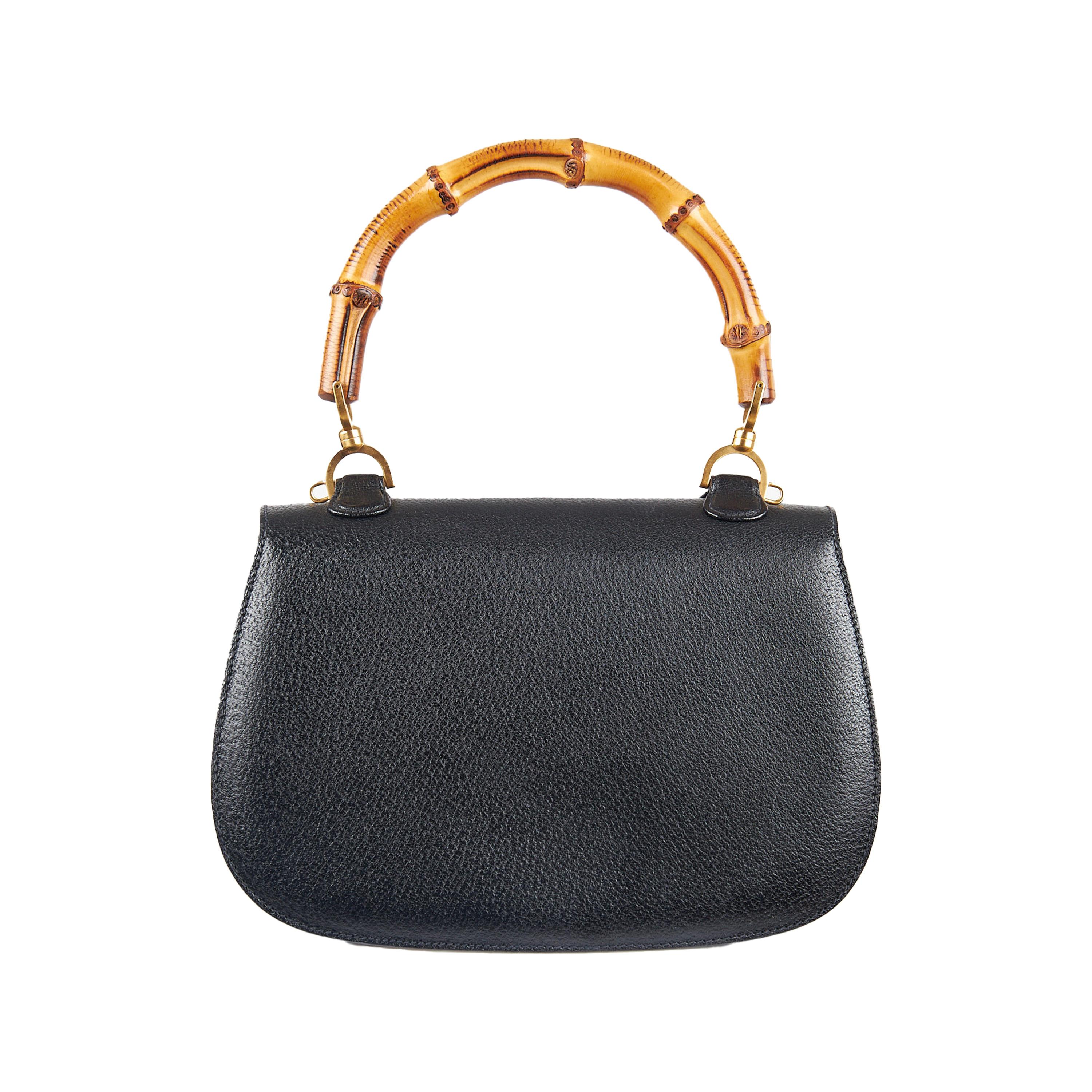 This Gucci 1947 Bamboo Bag is a timeless classic, originally released in the 1940s and re-introduced in the Fall/Winter of 2022 by Alessandro Michele. Crafted in a black calfskin leather matched with brushed golden hardware, it is the perfect