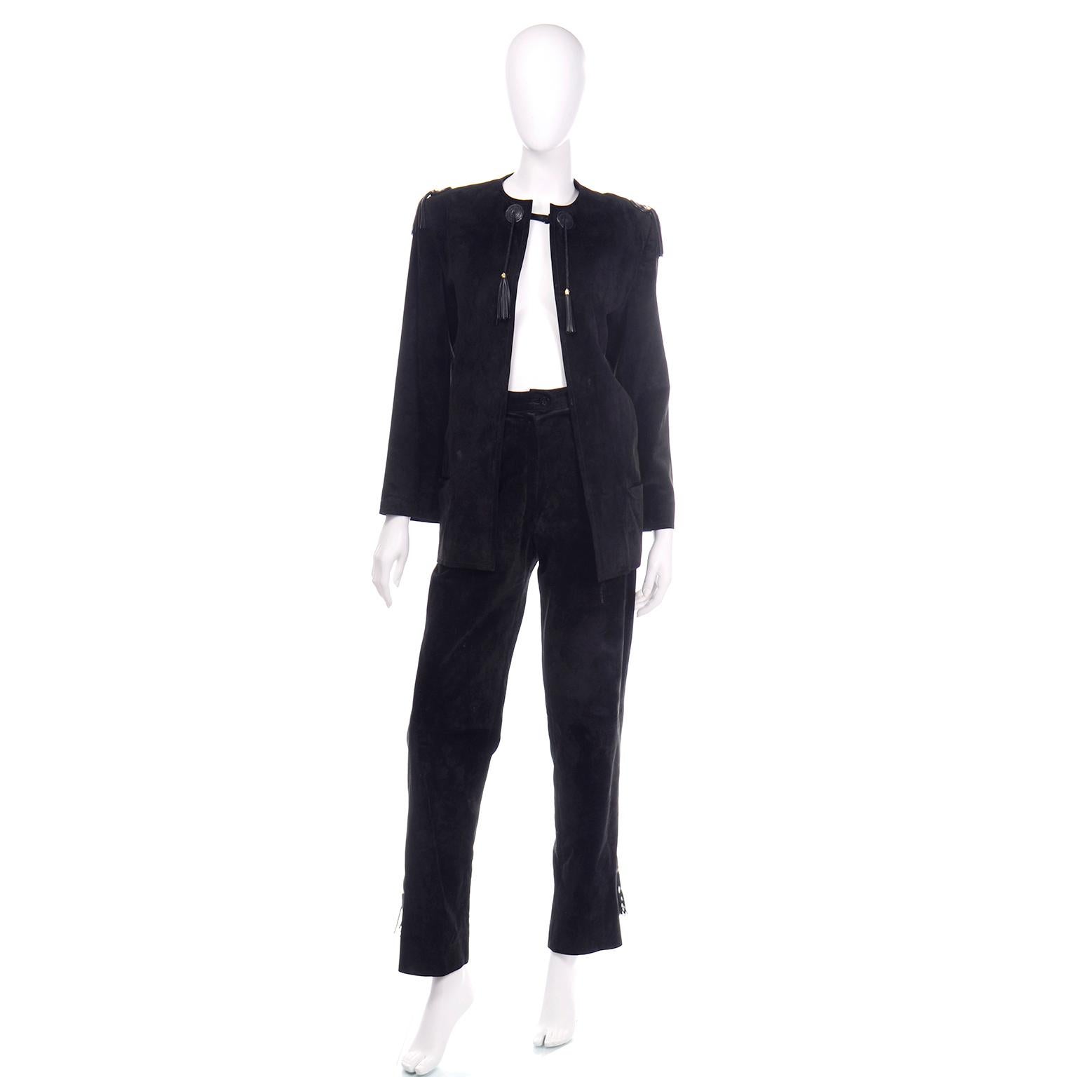 This is a such a fabulous vintage 1970's Gucci black suede pants and jacket suit with leather tassel details.The  jacket has tassels on the shoulders and collar and closes with a single button at the top of the neck The pants are high waisted with a