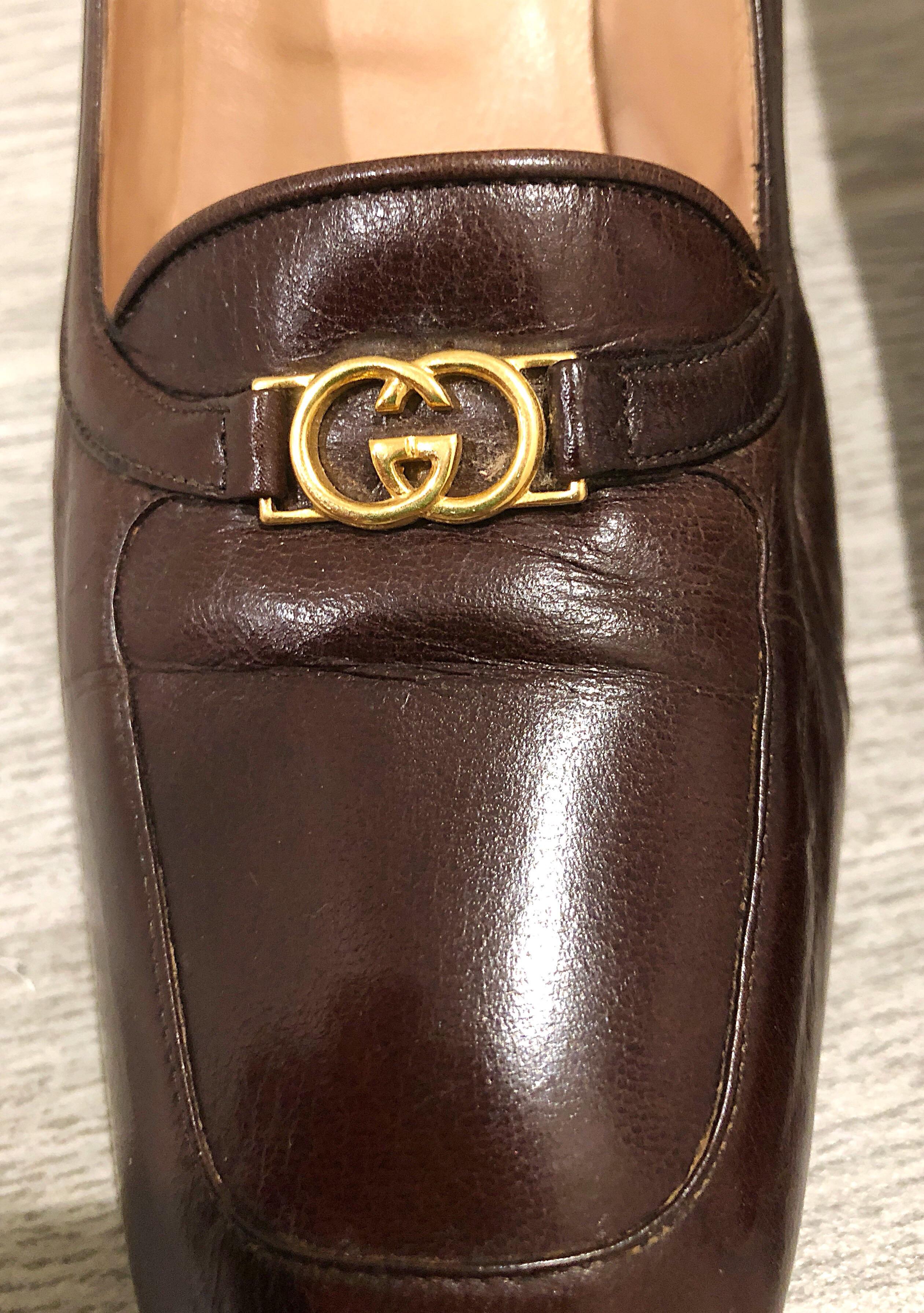 Rare 1970s Gucci Size 7.5 chocolate brown leather women’s high heel loafers! The perfect brown color that goes with anything. Gold GG logo detail on each shoe. Can easily be dressed up or down. Great with jeans, a dress, a suit, or skirt. In good