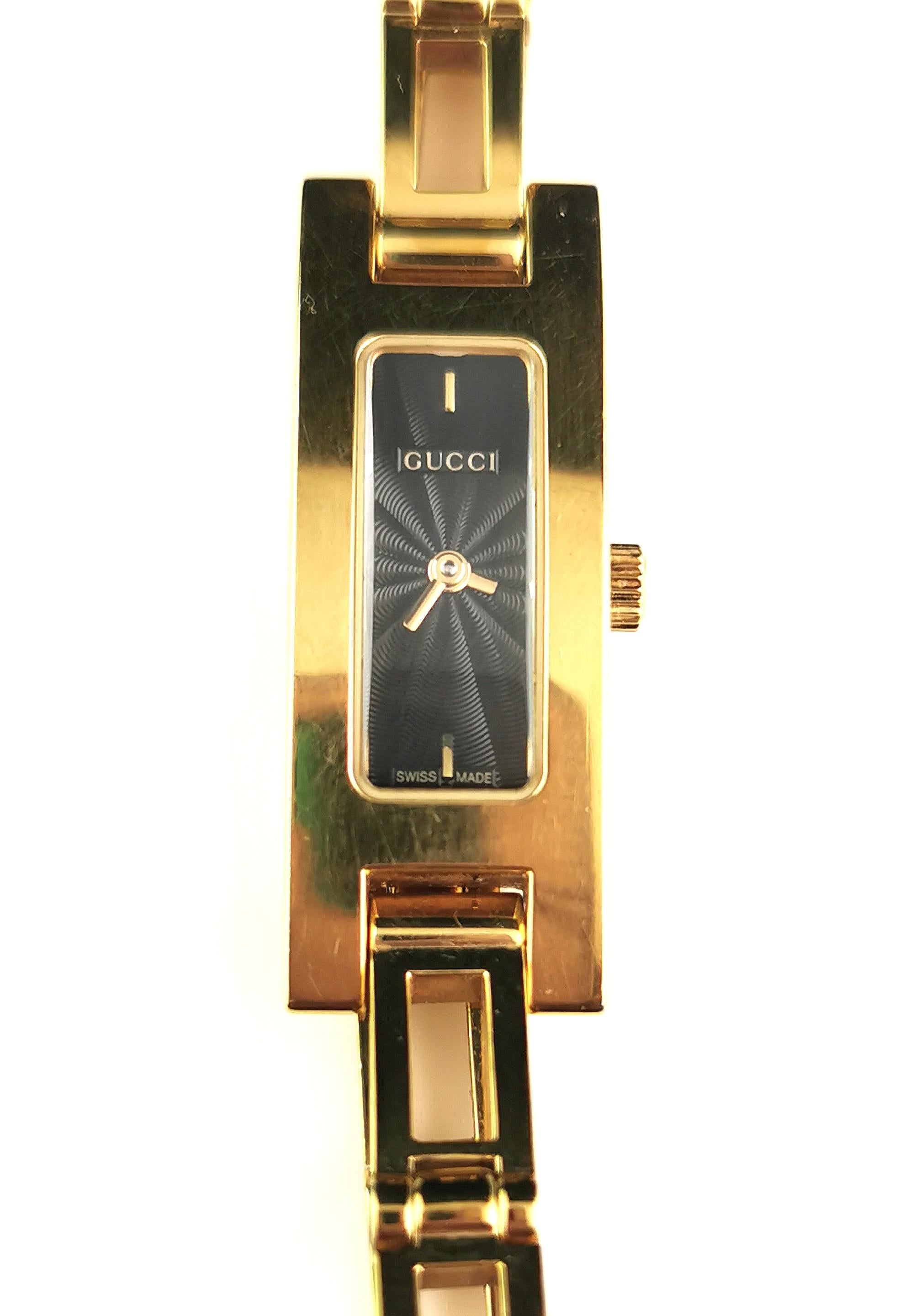 A stylish ladies Gucci 3900l gold plated watch.

This is a bracelet strap watch with an elegant rectangular shape face and a rich black dial.

Most often come in white dial colour so this is a particularly nice one.

It is gold plated stainless