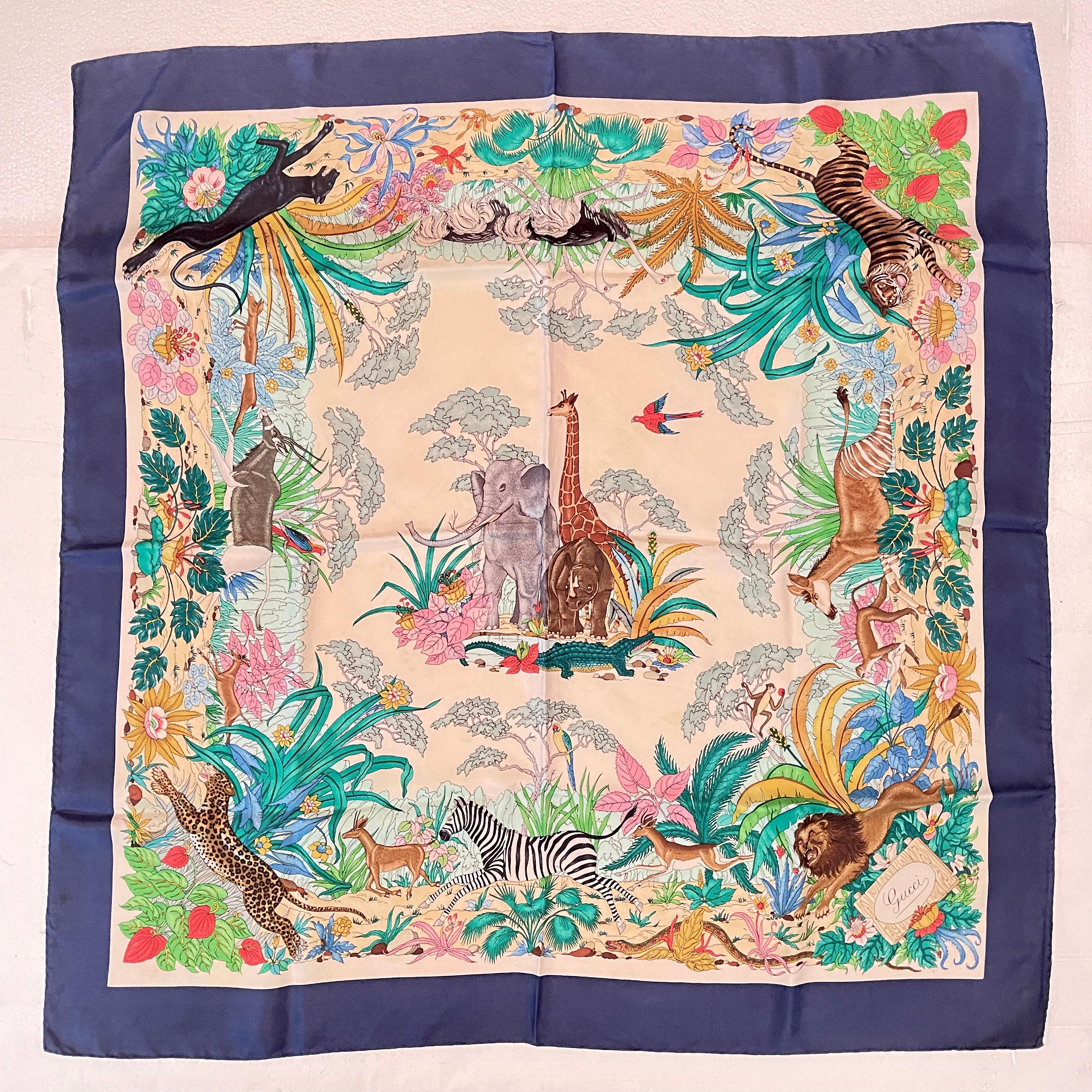 From the Italian fashion house Gucci, and designed by Vittorio Accornero, a vintage silk scarf with an African jungle animal and big cat theme, circa 1970s.

Boldly colored and beautifully detailed, a central motif of Big Game animals – an elephant,