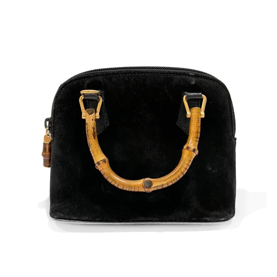 Vintage Bamboo Handle Suede Mini Bag by Gucci 
Circa 2007
Made in Italy 
Black suede
Dual bamboo top handles
Bamboo zip detail
Top zip closure
Gold-tone hardware 
Interior pocket with zip closure
Leather bottom
Great Vintage Condition; Preloved with