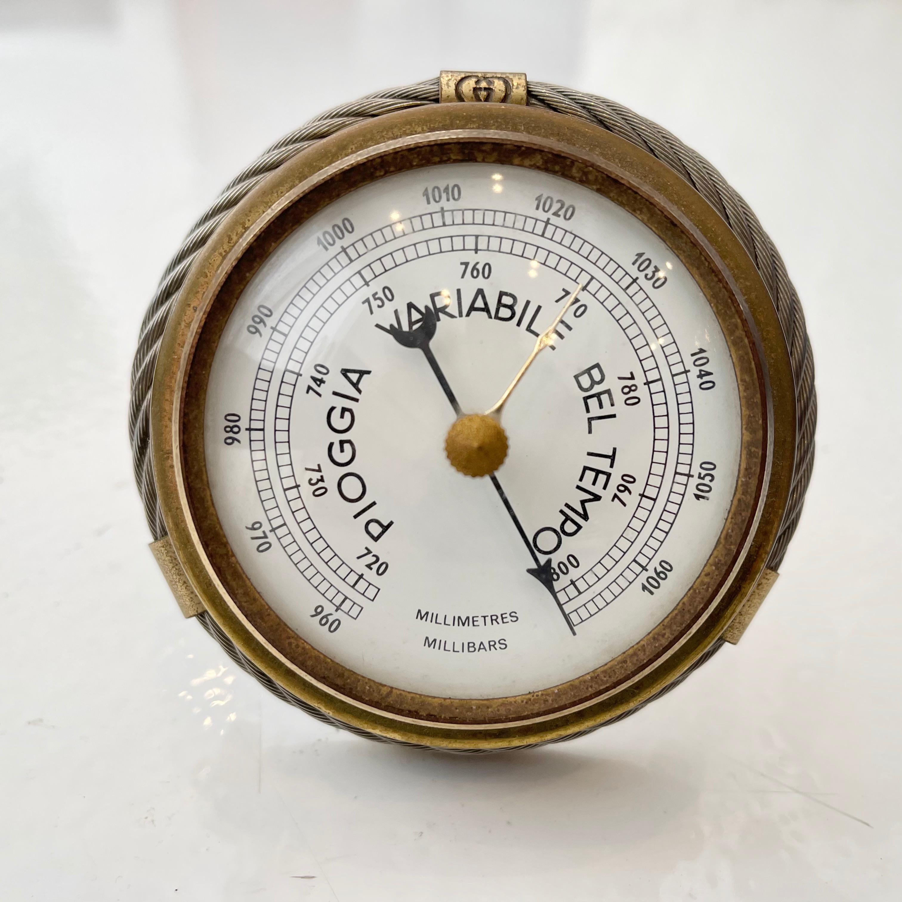 Vintage barometer by Gucci with beautiful nautical design details. Metal wire woven like a rope with brass accents, bearing the classic double linking Gucci G's at top center, wraps around the object.. The barometer is finished off with a bubble