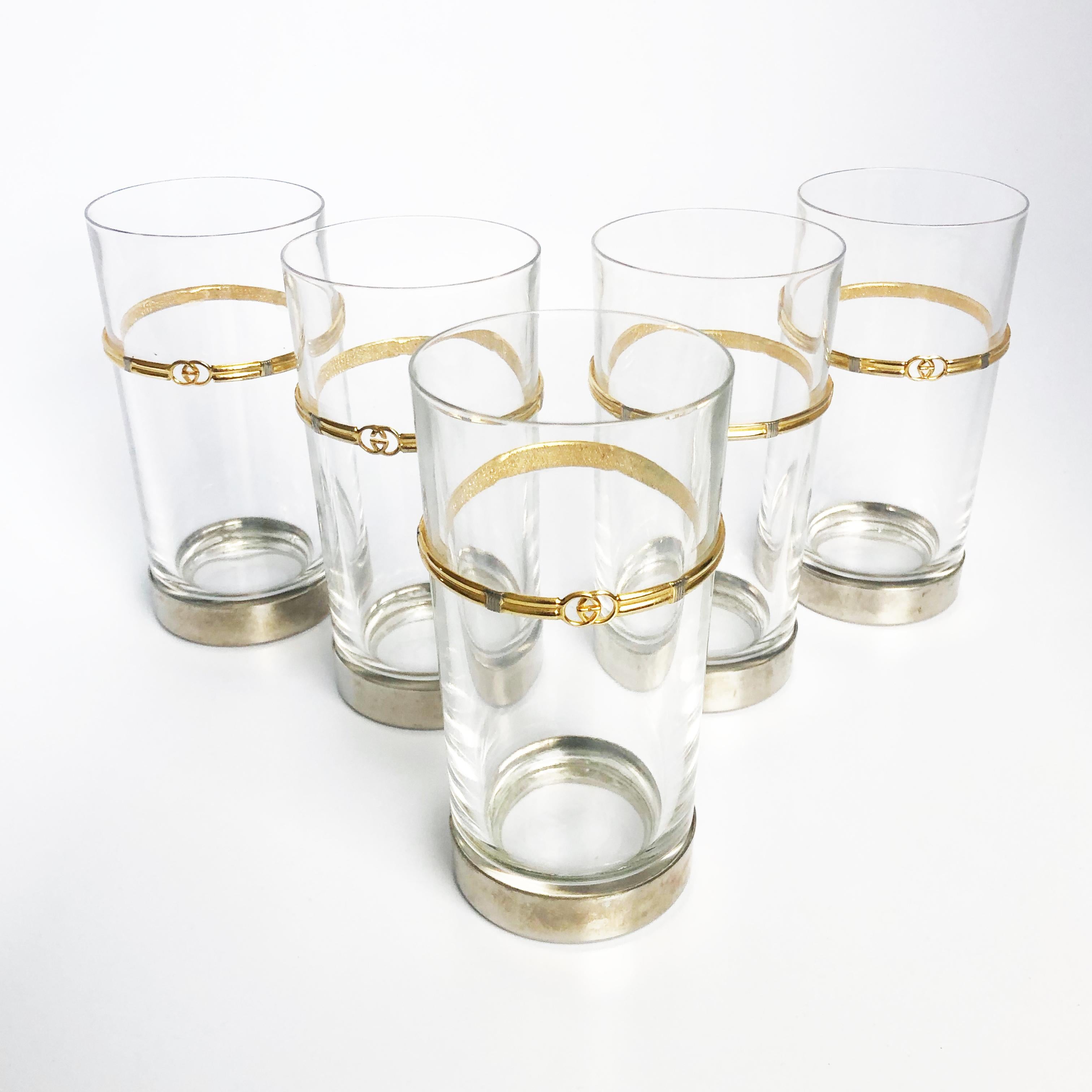 Entertain in style with this Gucci Barware Set (five) Crystal High Ball or Cocktail Glasses with Gold GG logo and silver plated bases.  One super rare set, likely made in the late 70s.  Each glass measures appx 6in H x 2.5in D.  Preowned/vintage