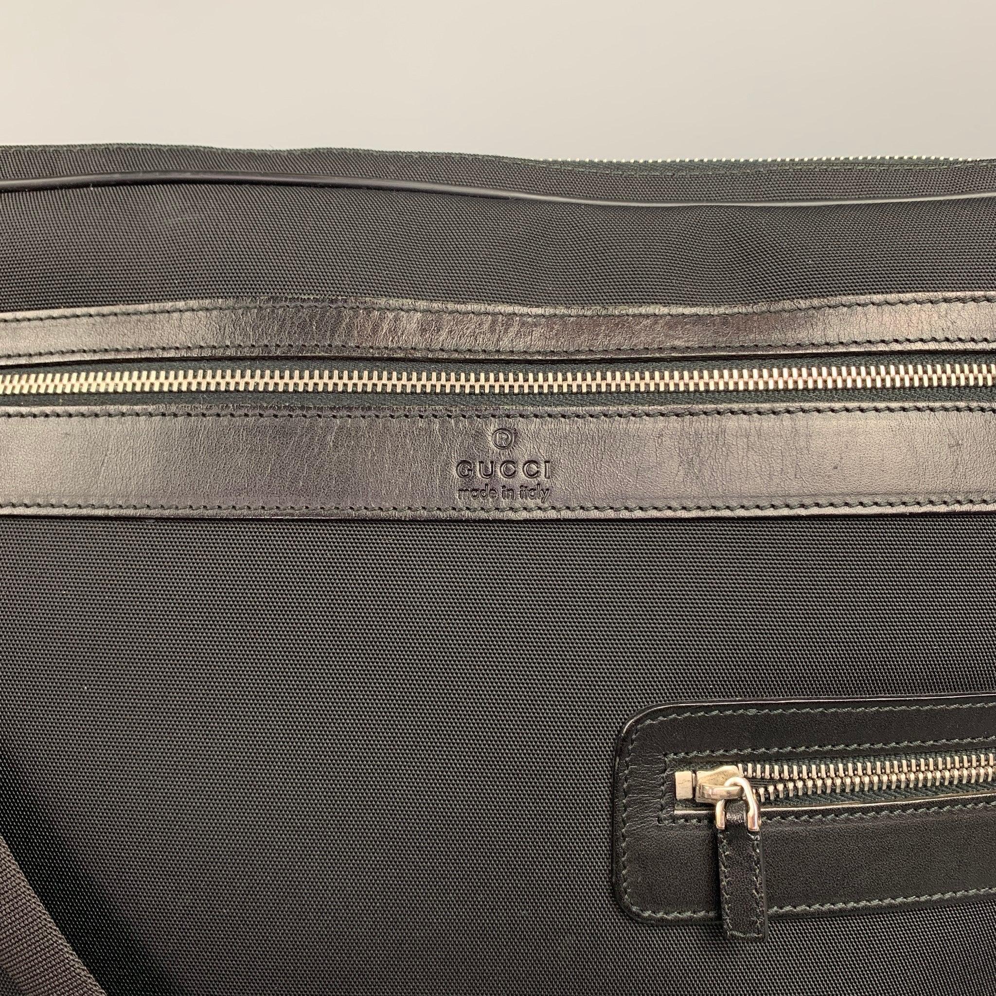Vintage GUCCI messenger bag comes in a black canvas with a leather trim featuring a removable shoulder strap, front zipper pockets, inner slot, and a zipper closure. Made in Italy.Very Good
Pre-Owned Condition. 


Measurements: 
  Length: 14.5