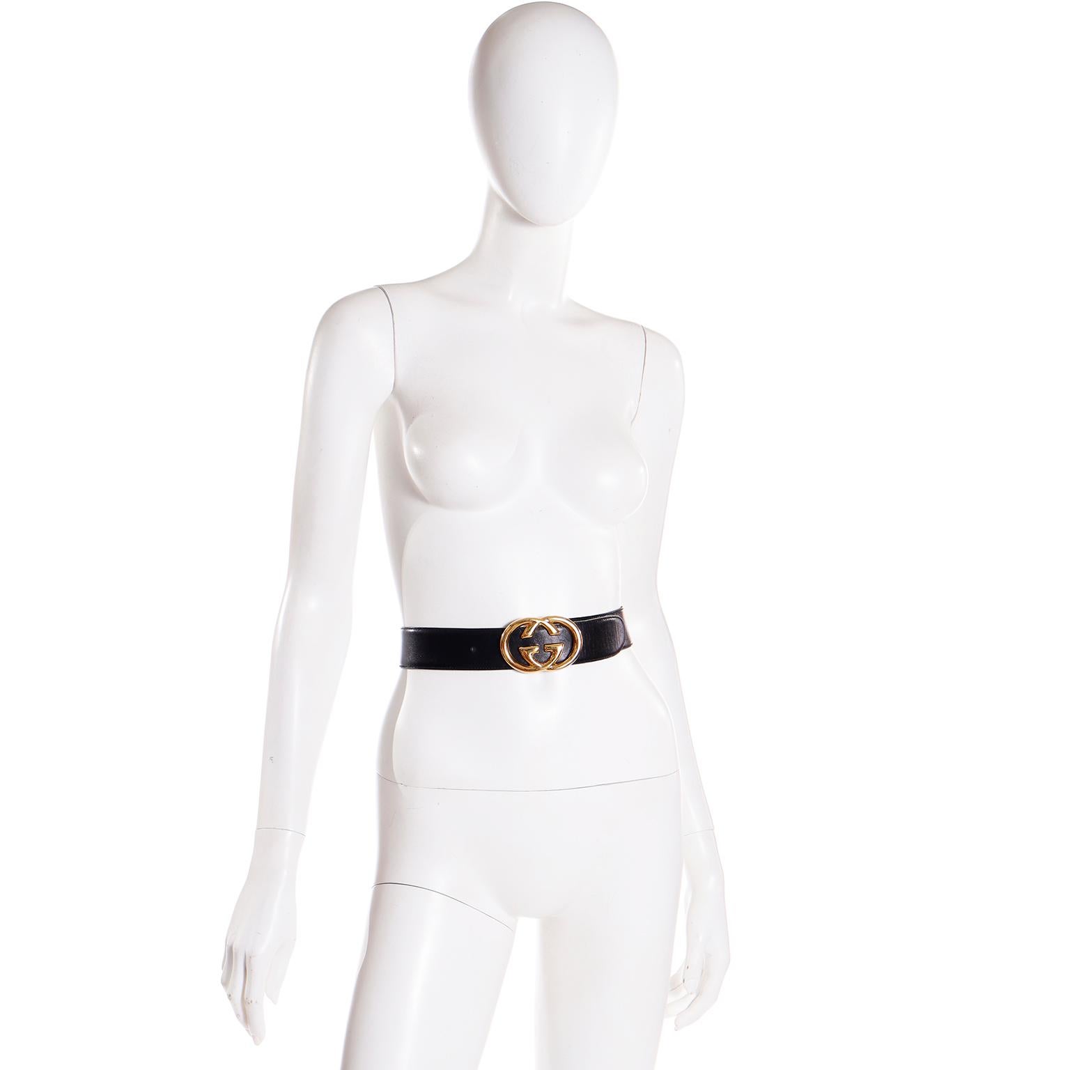 This vintage late 1980's black leather Gucci belt is so timeless and can add so much style to any outfit! We especially love the large interlocking mirror image double G gold metal buckle! The belt is marked Made in Italy by Gucci 75-30. The buckle