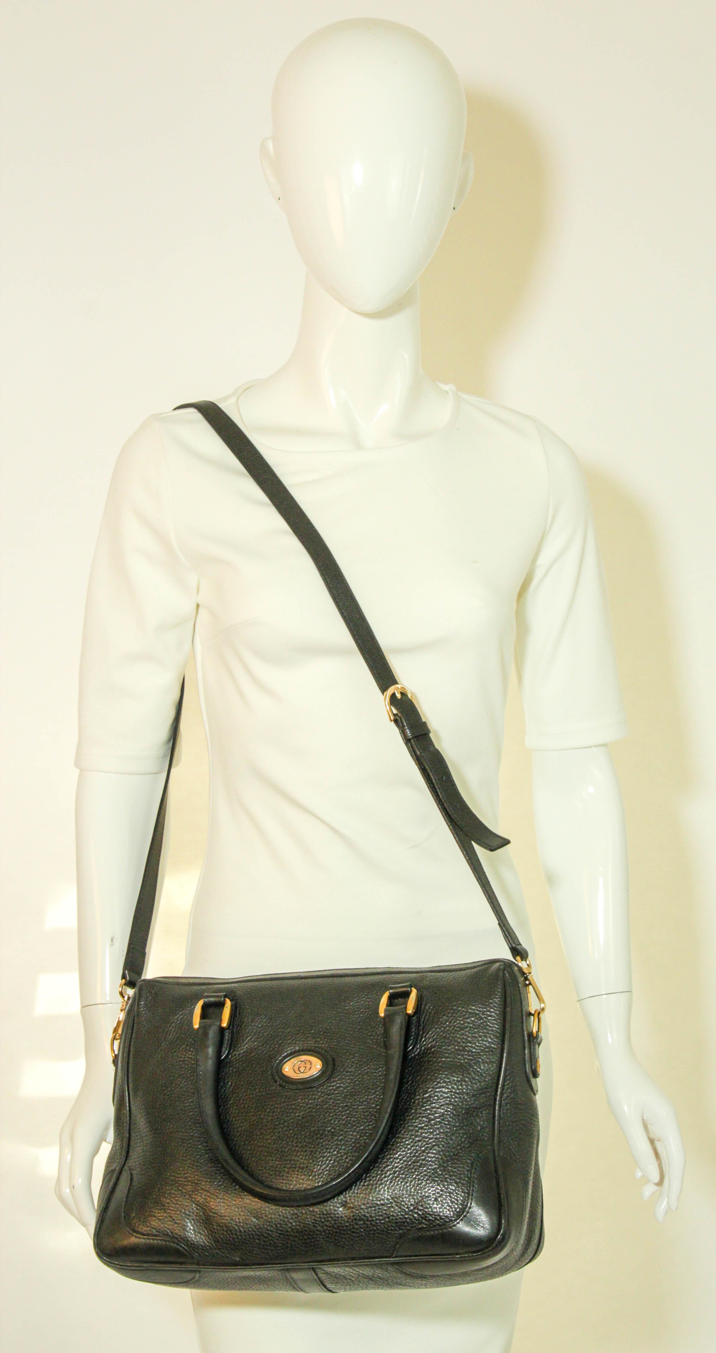 Vintage GUCCI Black Leather Bag.
Vintage Black Leather Boston Top Handle Bag.
Black leather, double zipper top closure
Interior black Gucci monogram cloth lining
Interior main compartment.
Interior zipper pocket.
Dimensions: 9in H x 12.5in W x 5.5in