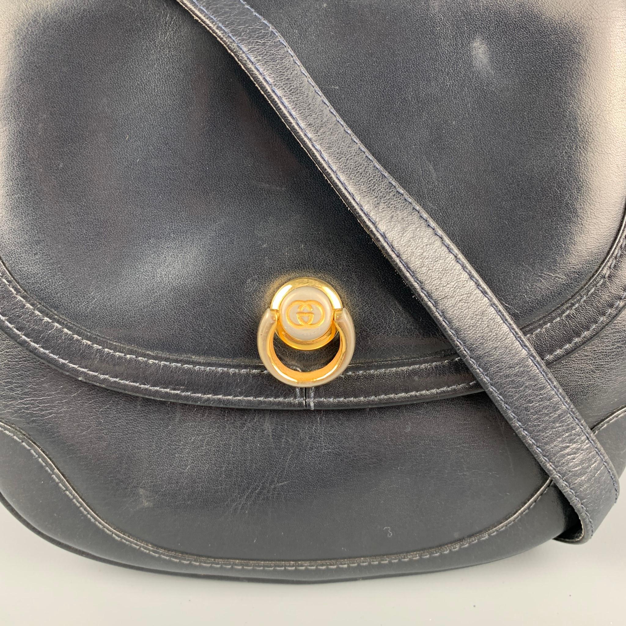Vintage GUCCI bag comes in a black leather featuring a mini size style, gold tone hard ware, two inner department, removable shoulder strap, and a snap button closure. 

Good Pre-Owned Condition.

Measurements:

Length: 7 in.
Width: 2 in.
Height: 6