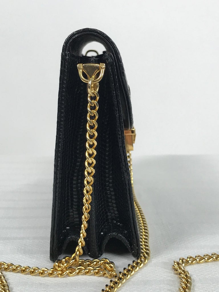Vintage Gucci black lizard evening bag gold hardware 1970s. The perfect bag when you don't want to carry much, it holds most iPhones. Curved flap bag has the Gucci logo at the lower front center with the gold push tab lock below, the long gold chain