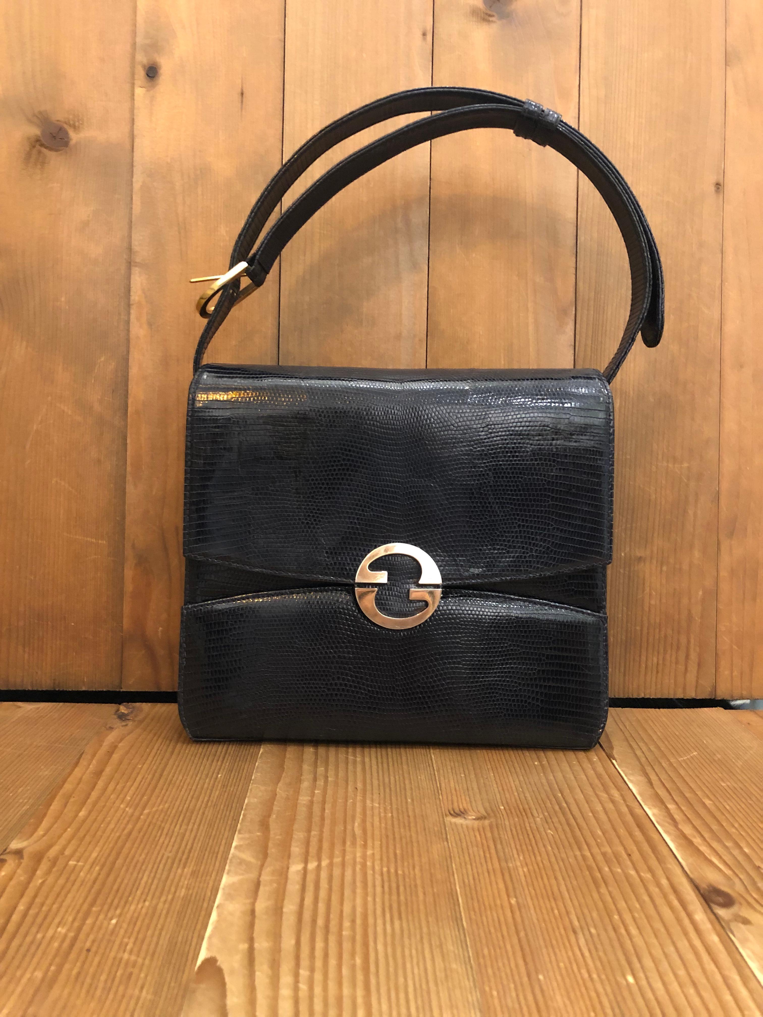 This vintage Gucci box shoulder bag is crafted of exotic leather in black featuring gold toned hardware. Front flap spring GG closure opens to black leather interior featuring three compartments including one middle compartment with flap closure.