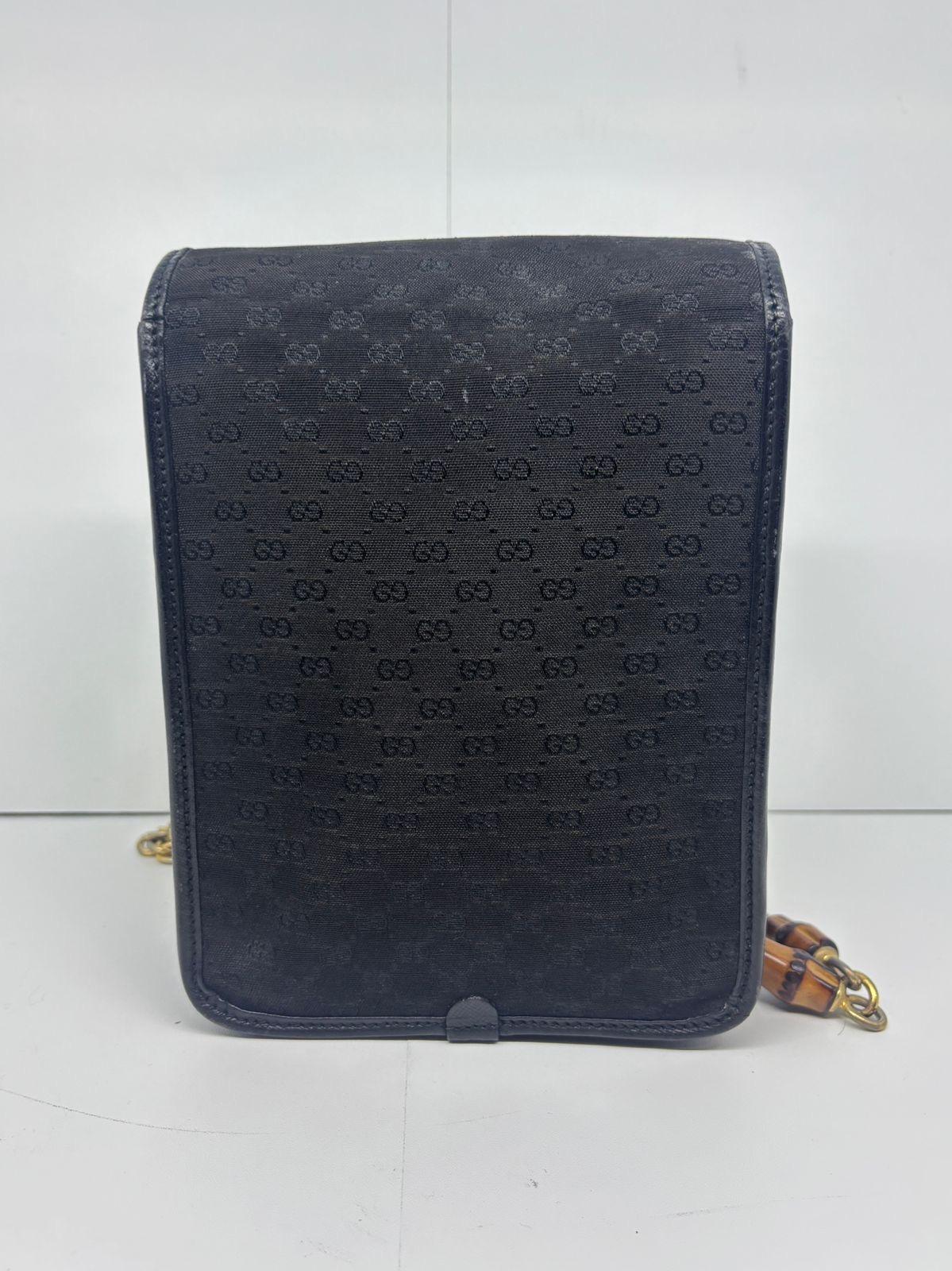 Vintage small GG Gucci canvas bamboo crossbody bag. Shaped like a phone holder bag. Bamboo details on the chain strap and front flap. Canvas body with saffiano like leather sides. Slight dryness due to storage on the leather. The body is a little