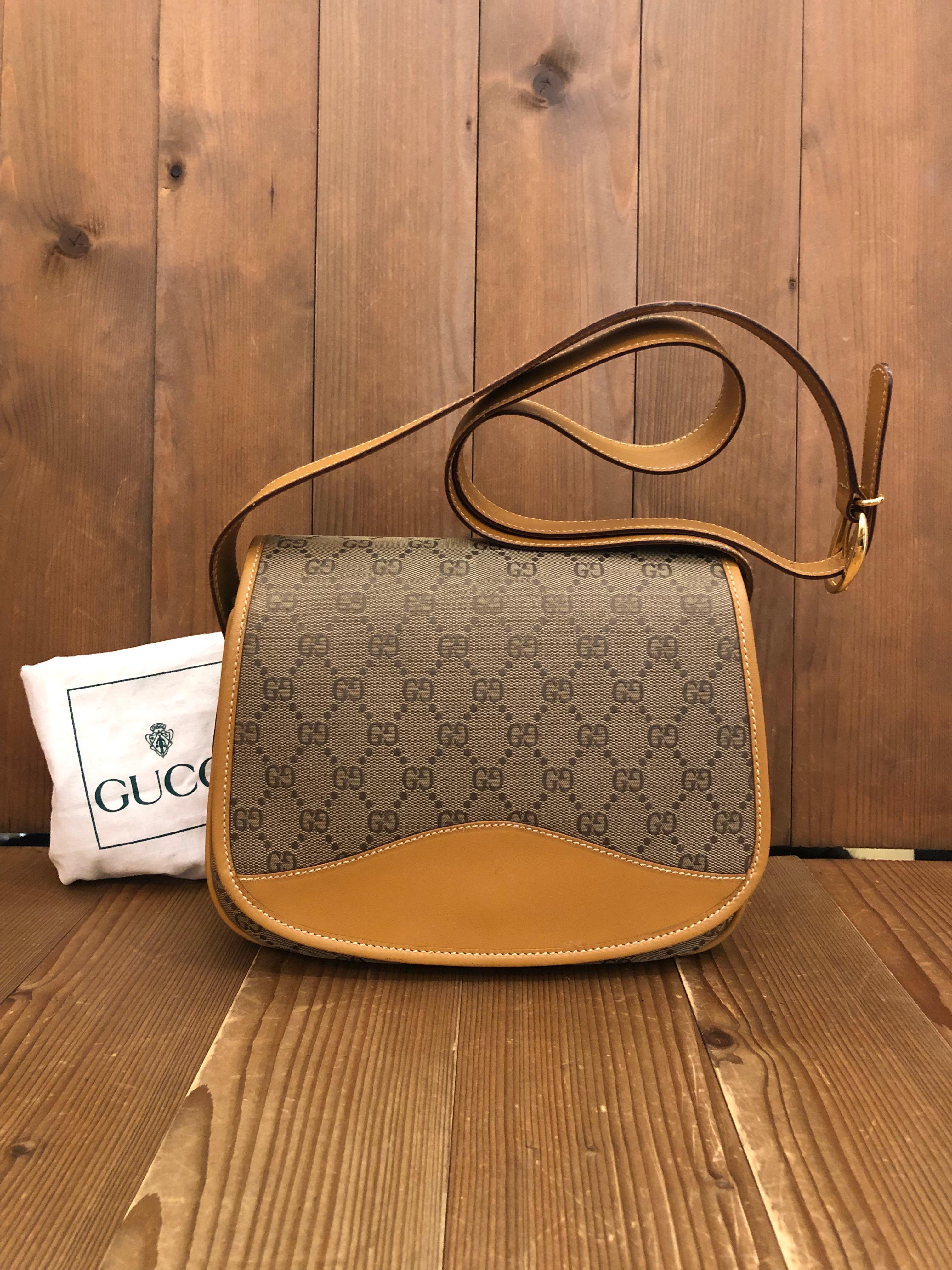 This Vintage GUCCI shoulder bag is crafted of GG jacquard in khaki trimmed with brown smooth leather. Front flap magnetic snap closure opens to new beige interior featuring three compartments and a zippered pocket. Made in Italy. Measures