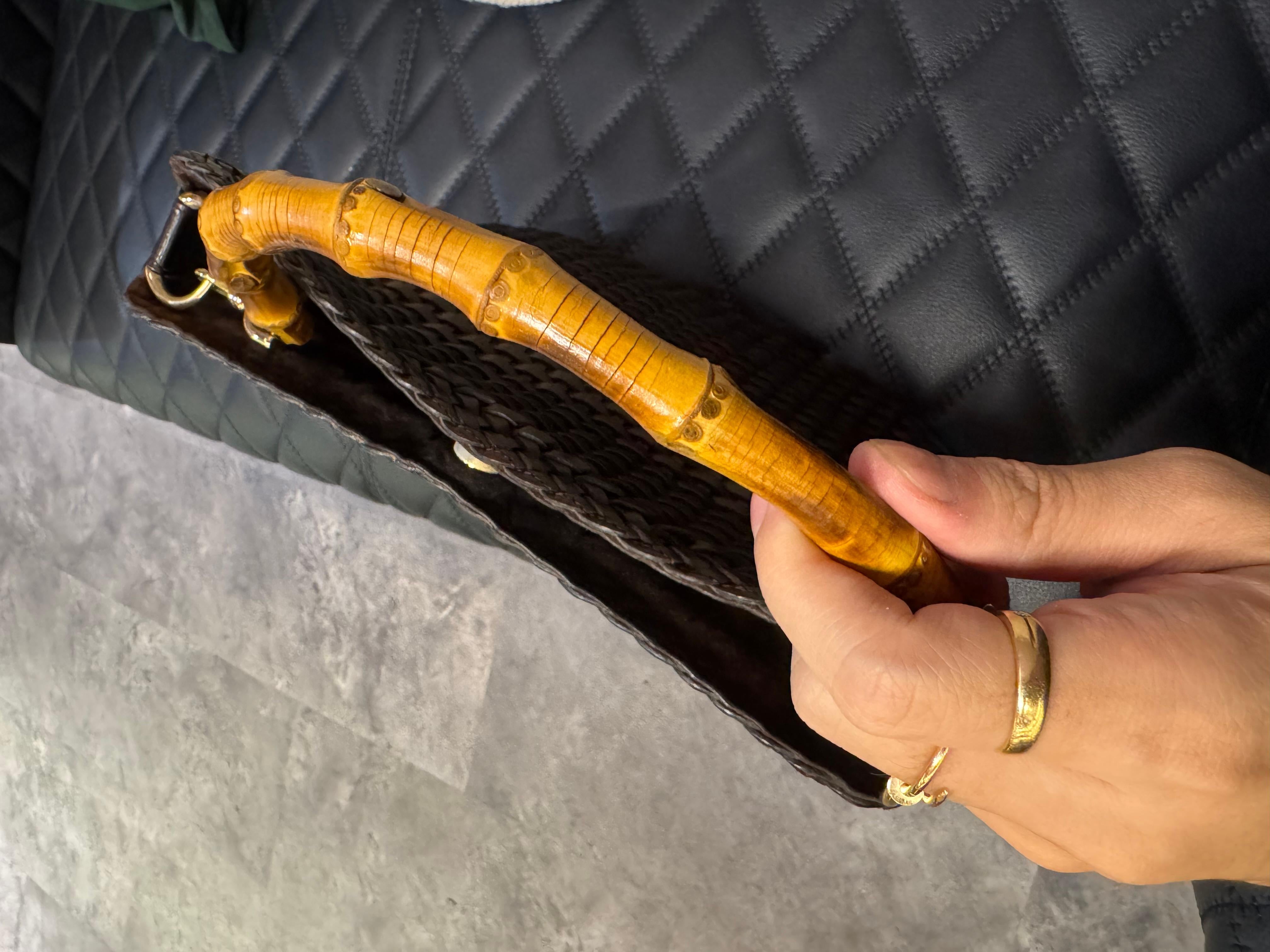 Vintage Gucci woven leather bag in brown. Very unique piece with Gucci’s signature bamboo handle. Perfect for casual bag. Slight marks on the suede lining. Minor cracks on the bamboo but not significant to the wear. Comes as is.