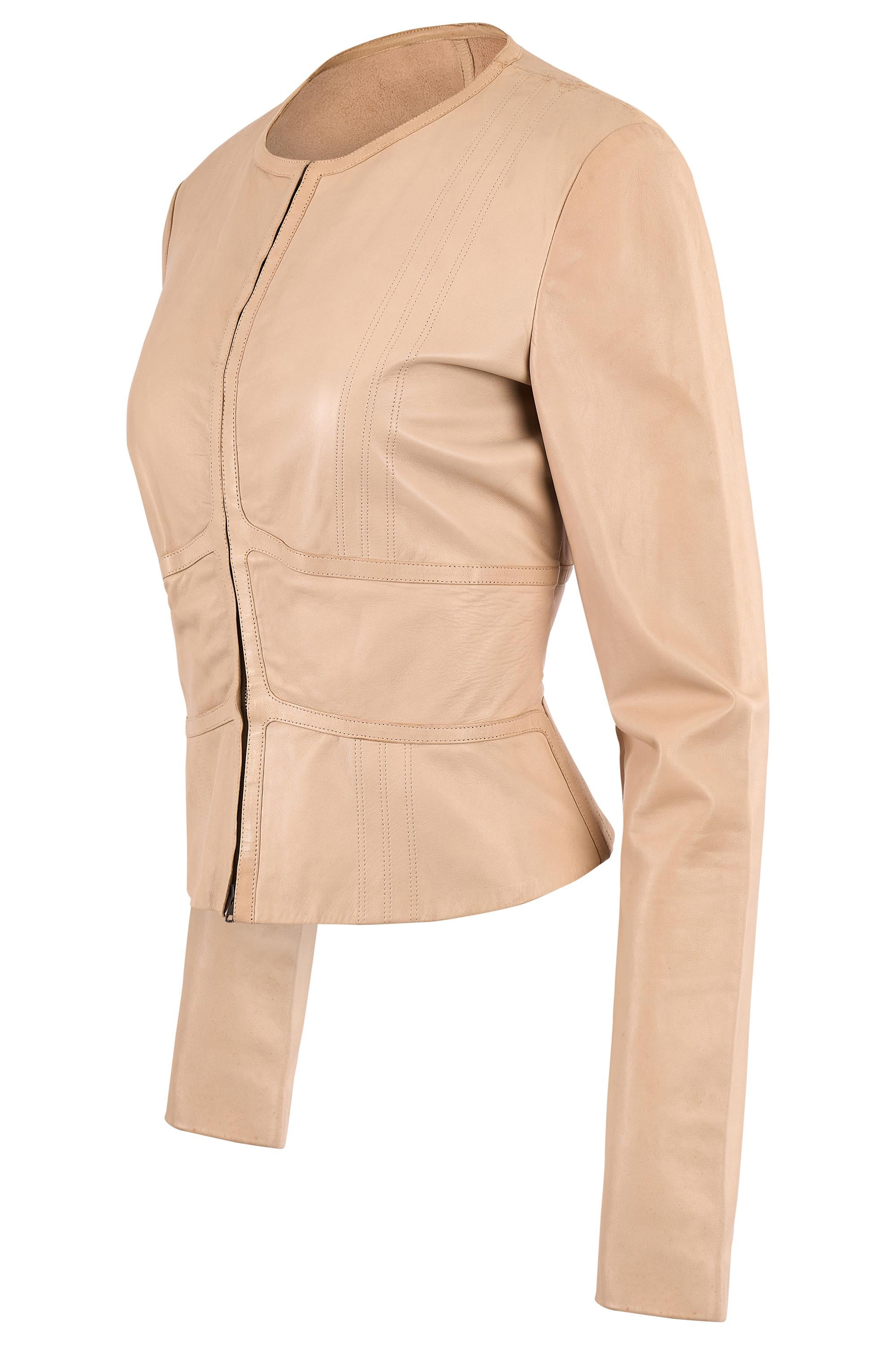 Gucci by Tom Ford leather jacket. Features a smooth nude leather with a refined minimalist silhouette, round neckline, subtle panel stitching that contours the body . The tailored fit flatters the waist, front double zip closure. In excellent
