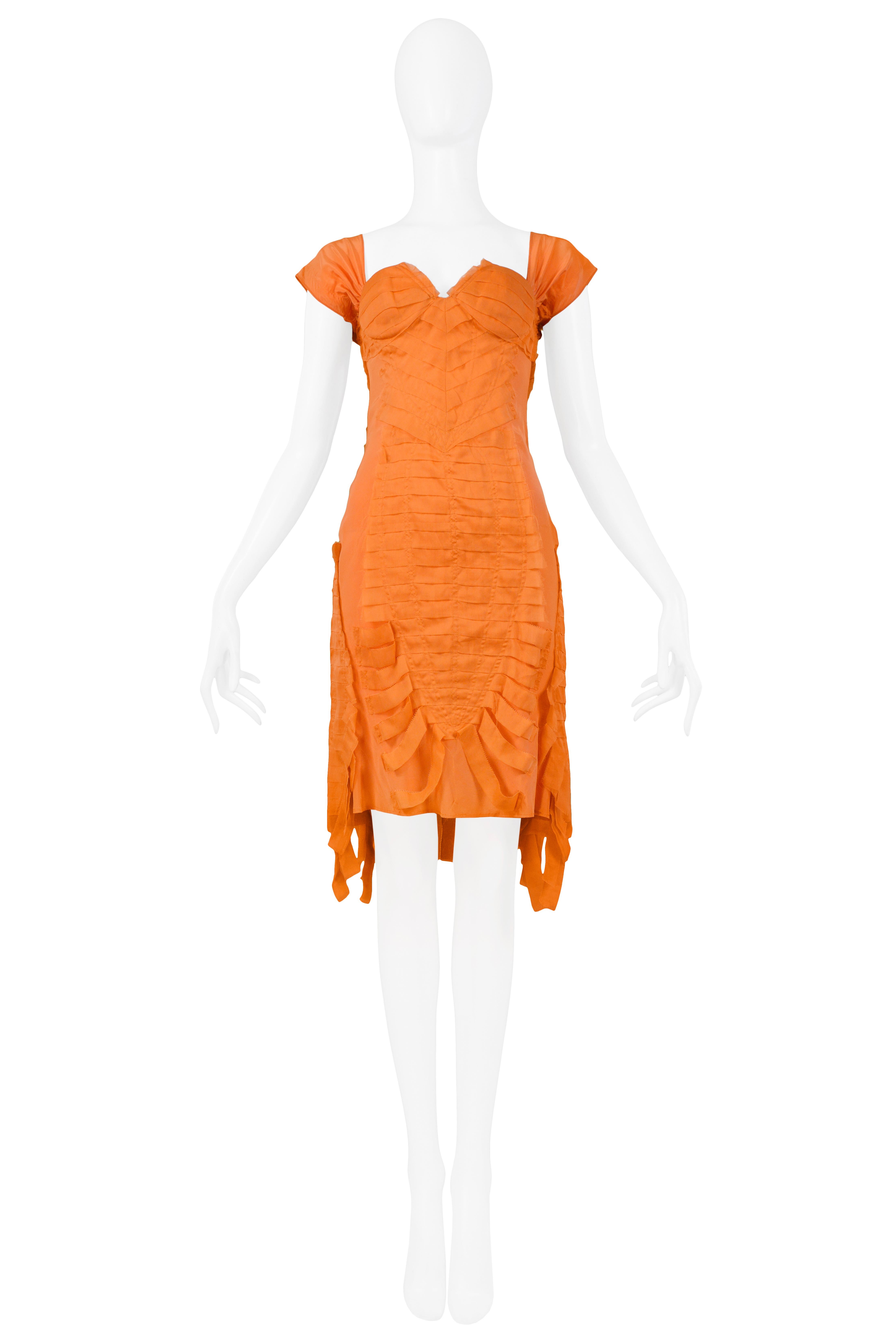 We are pleased to offer a vintage Tom Ford for Gucci orange silk spandex cocktail dress featuring cap sleeves and open back and embellished with raw edge pleated silk and fringe at hemline.

Gucci
Designed by Tom Ford
Size 40
Silk Spandex
2004