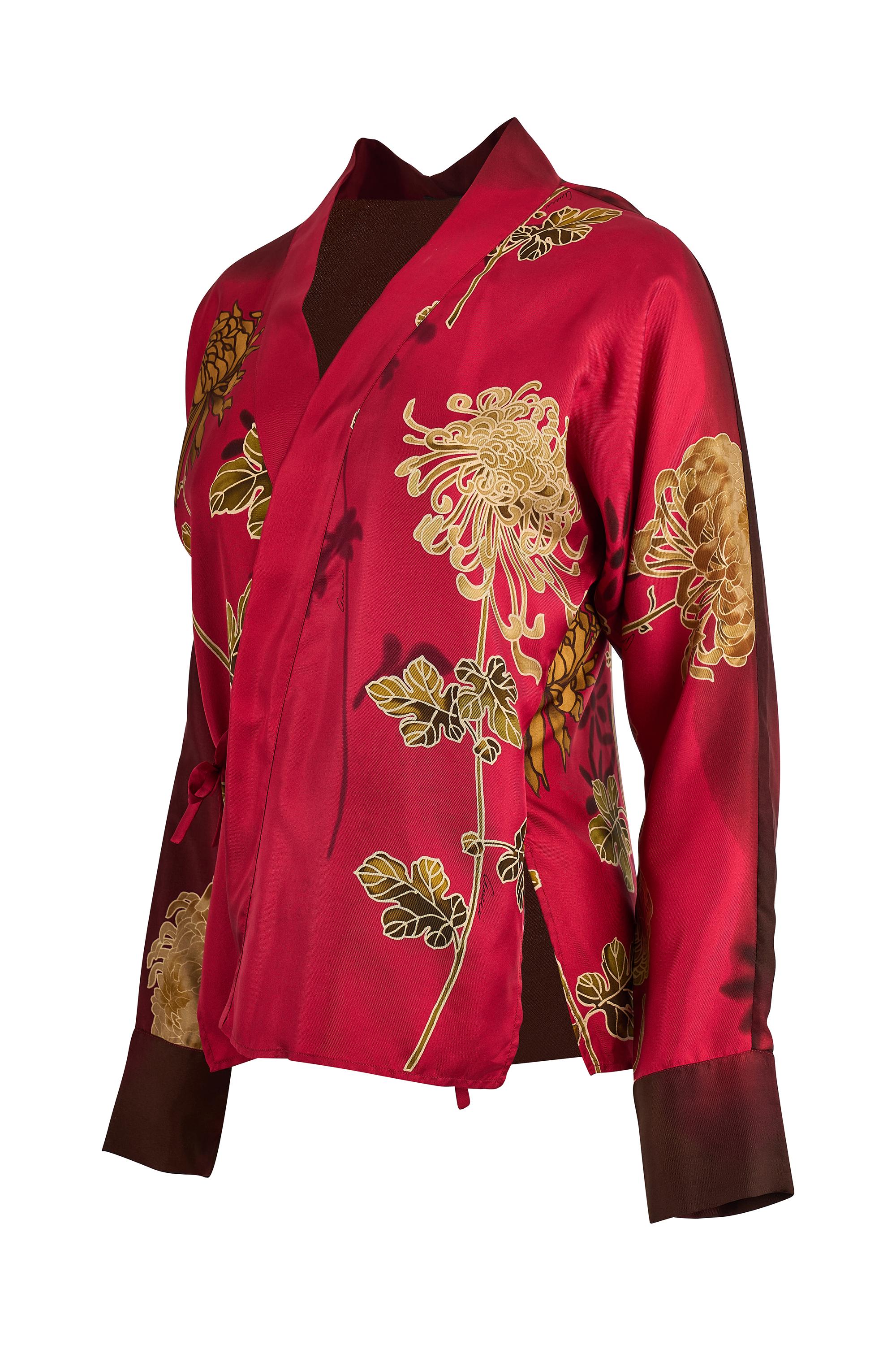 A rare and refined piece from Gucci Spring Summer 2001 collection under Tom Ford’s visionary direction. This sleek red long sleeve top is crafted from a luxurious  silk fabric that hugs the body in all the right places. Designed with a plunging