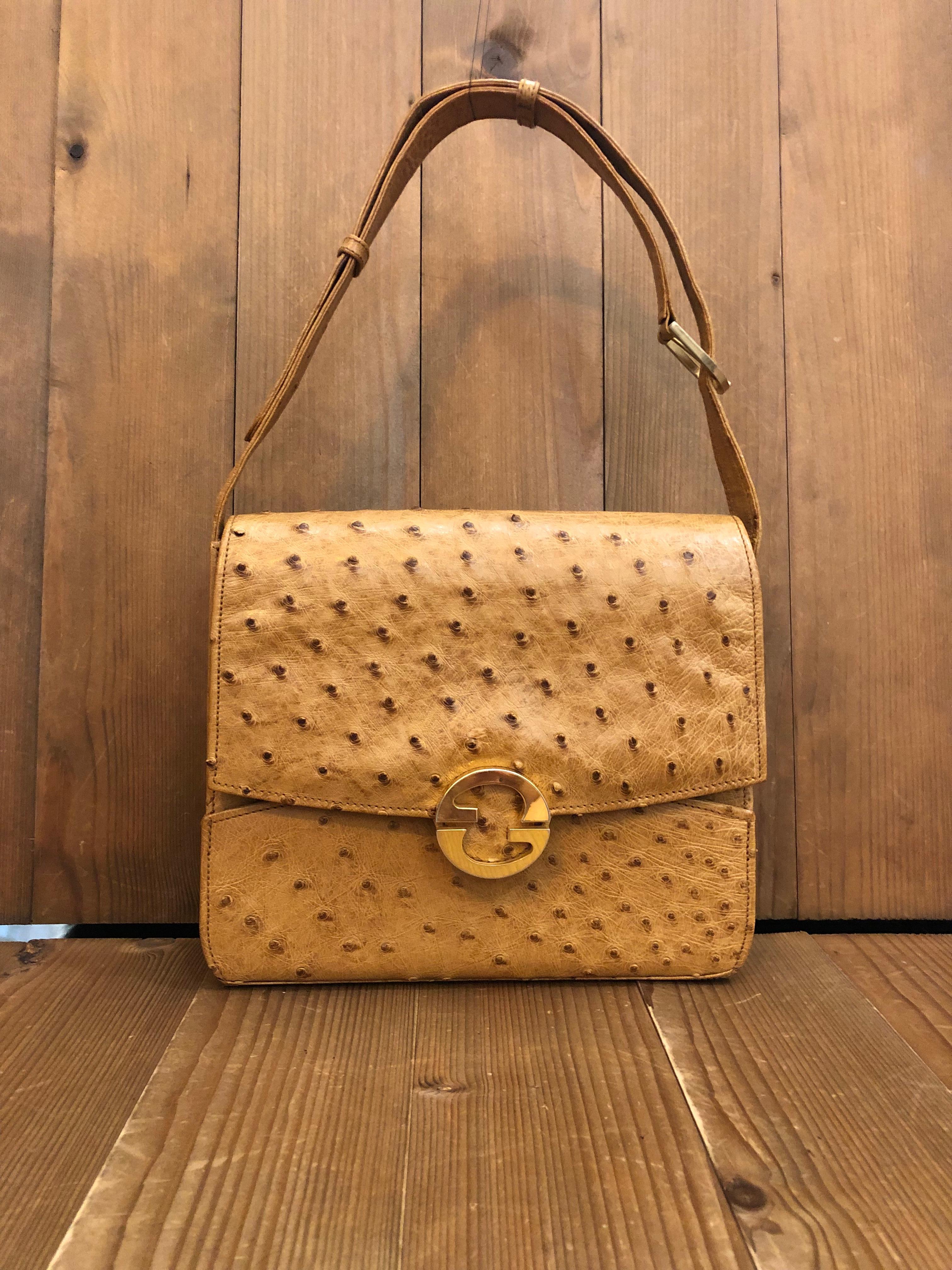 This rare vintage Gucci box shoulder bag is crafted of exotic leather in camel featuring gold toned hardware and brown lambskin leather interior. Front flap spring GG closure opens to three compartments including one middle compartment with flap