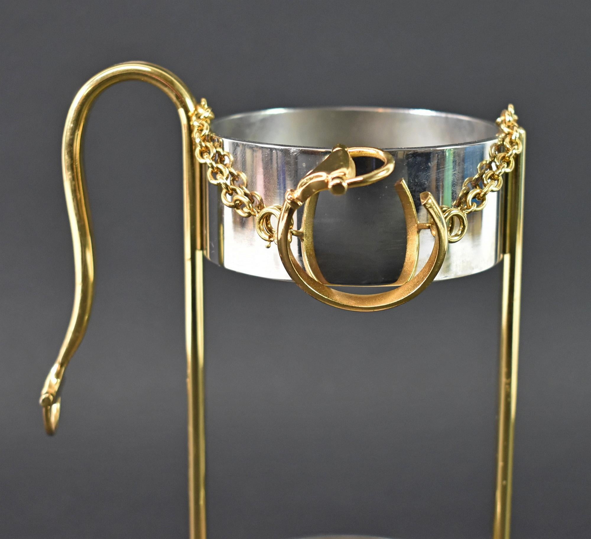 Vintage Gucci Chrome and Brass Wine Bottle Holder. circa 1970s. Stirrup on handle and neck holder. Mark Gucci, Made in Italy on bottom. Holds a standard bottle of wine. Good condition, wear consistent with usage and age, some fingerprints are shown