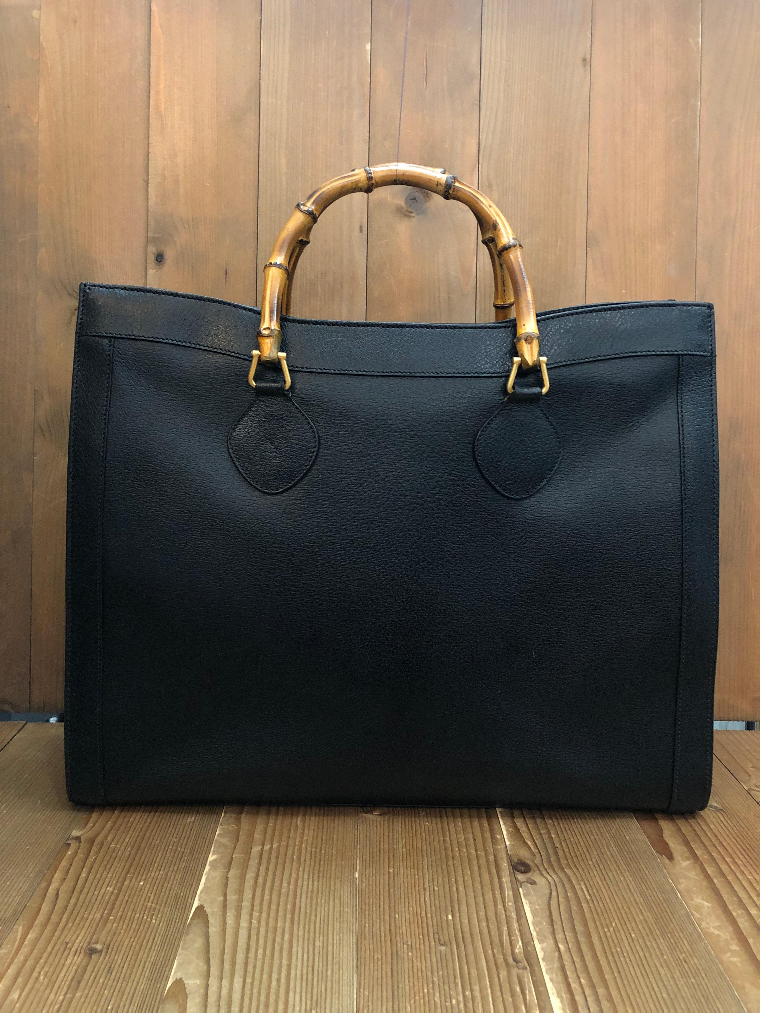 This vintage Gucci Diana Bamboo tote is crafted of pigskin leather in black featuring matte gold toned hardware and bamboo handles. Top flap magnetic snap closure opens a new interior in black featuring two main open compartments and one middle