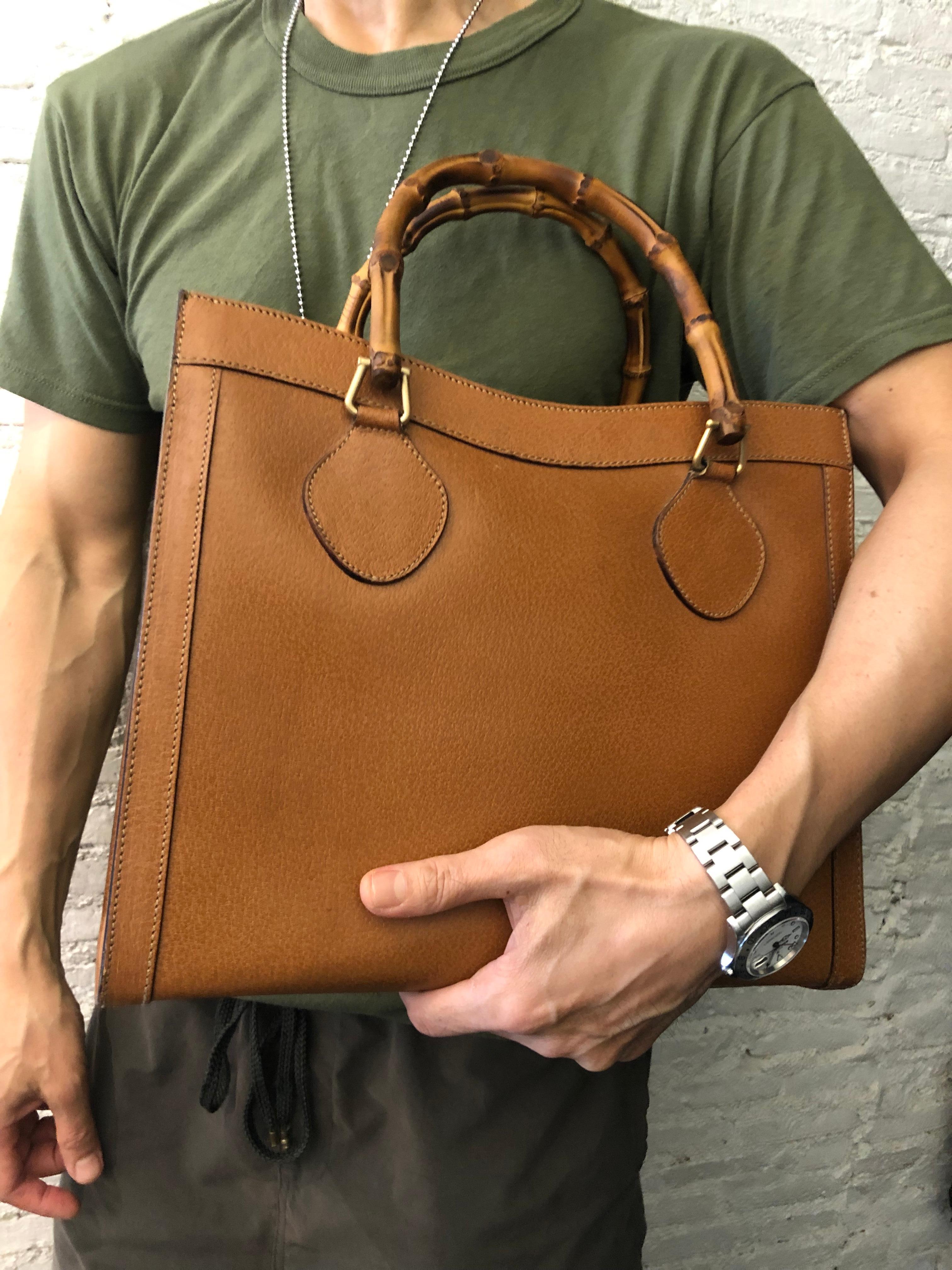This vintage GUCCI Diana bamboo tote is crafted of pigskin’s leather in caramel brown featuring matte gold toned hardware and bamboo handles. Top magnetic snap closure opens to a new interior in beige featuring two main compartments/one zip